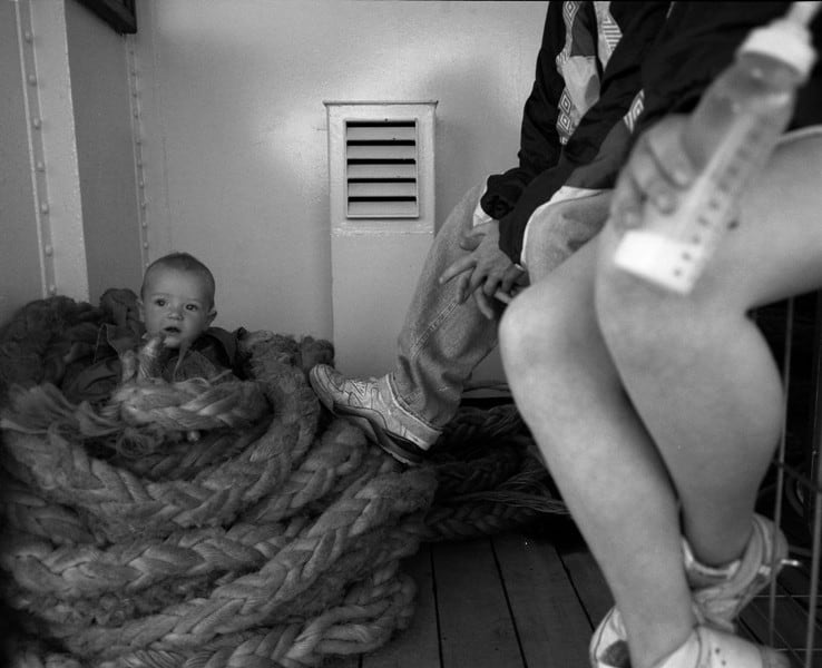 Ken Grant, Young parents and child in ropes on Mersey ferry, c1992