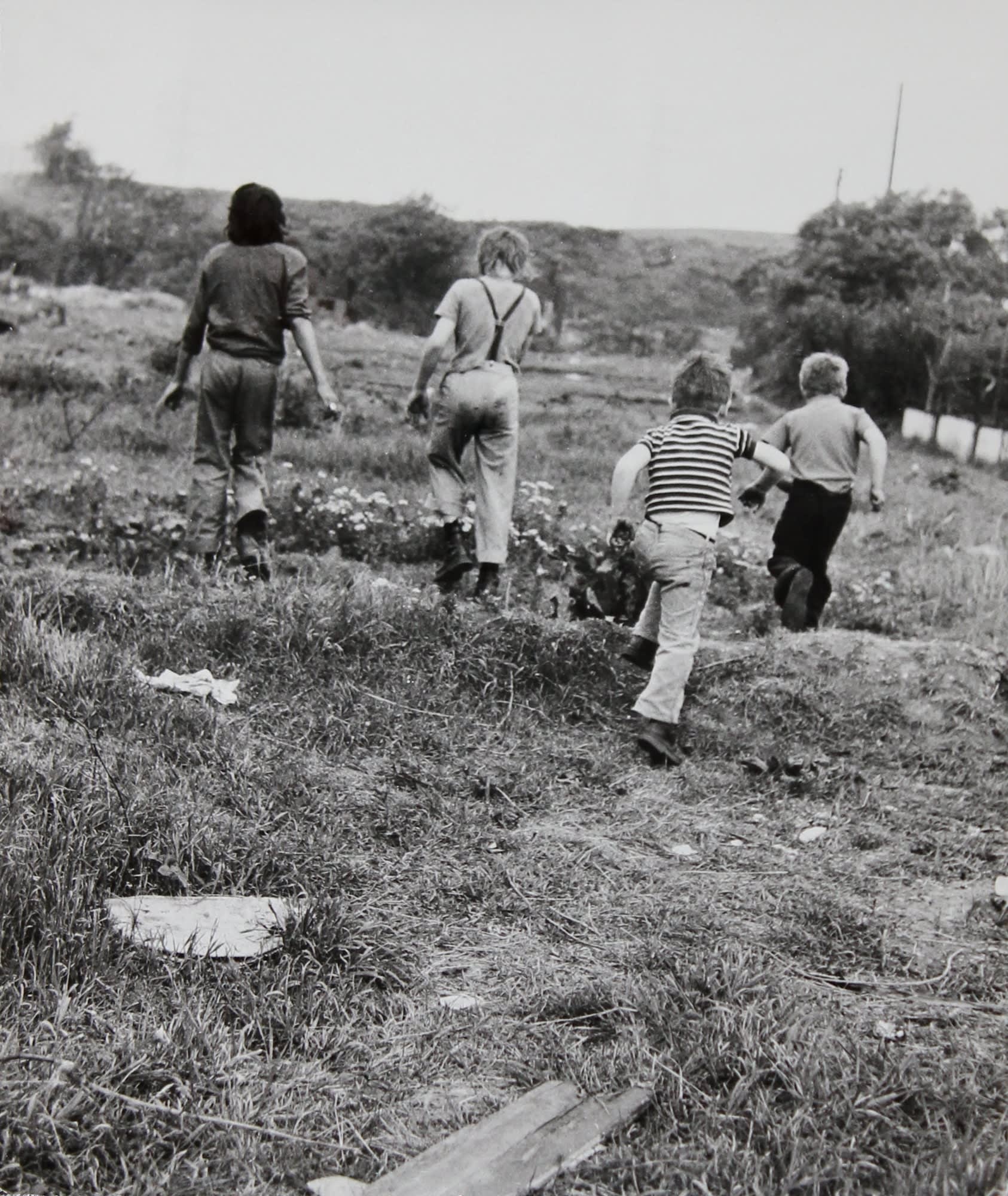 Jo Spence, Gypsies (boys from behind in a field), 1974