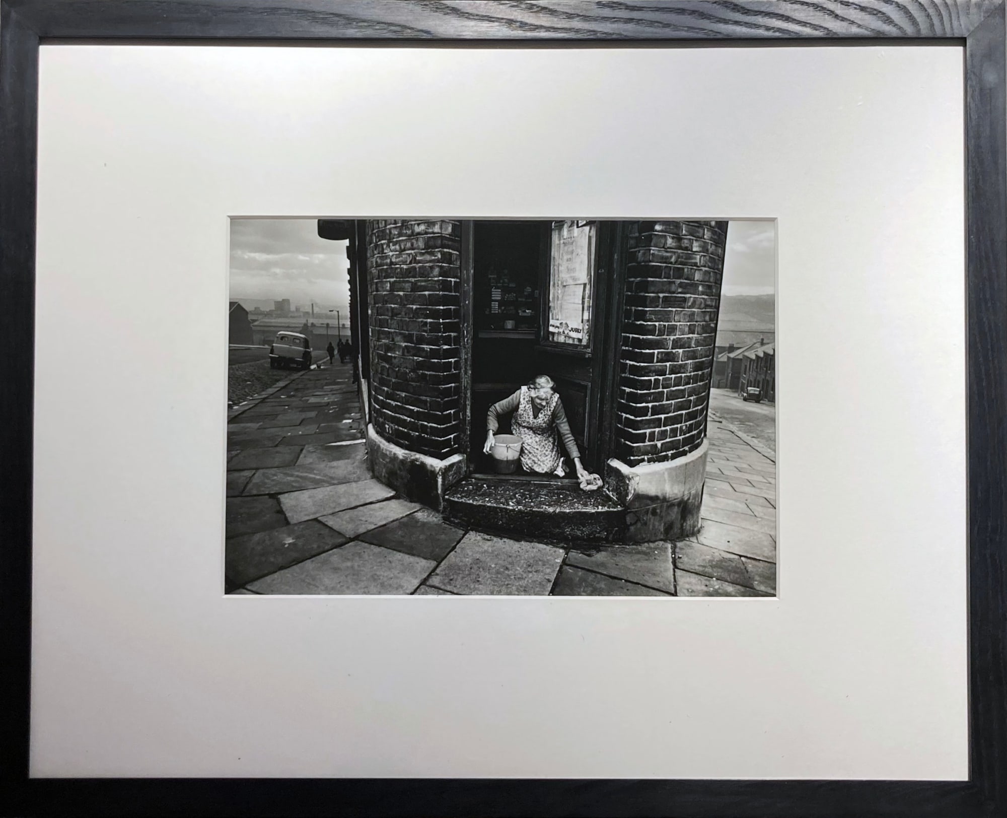 Colin Jones, A Shopkeeper Washing her Doorstep, Newcastle, 1963