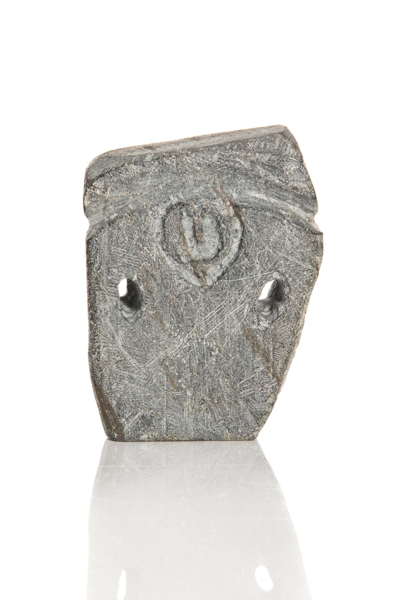 JOHN KAVIK (1897-1993) KANGIQLINIQ (RANKIN INLET) Standing Figure with Pack stone, 4.25 x 3 x 1.25 in (10.8 x 7.6 x 3.2 cm) unsigned. $1,500