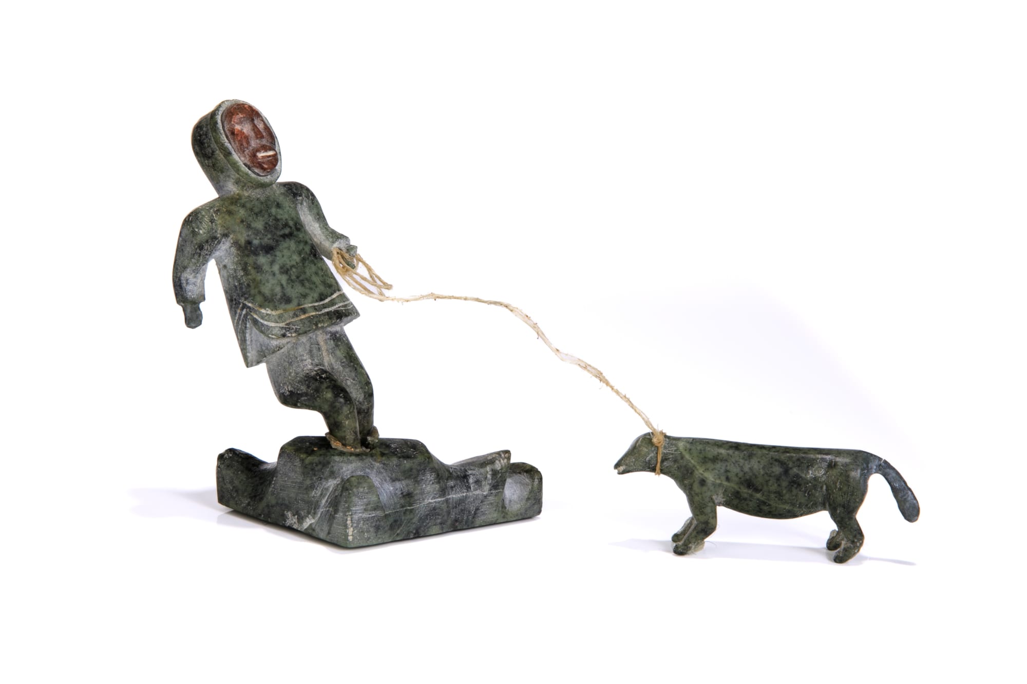 Lot 44 UNIDENTIFIED INUIT ARTIST, EASTERN CANADIAN ARCTIC Standing Hunter with Inset Face and Dog, c. late 1940s or early 1950s stone, sinew, and inlay, dimensions variable, overall: 4 x 3 x 3 in (10.2 x 7.6 x 7.6 cm) ESTIMATE: $400 — $600 PRICE REALIZED: $427.00