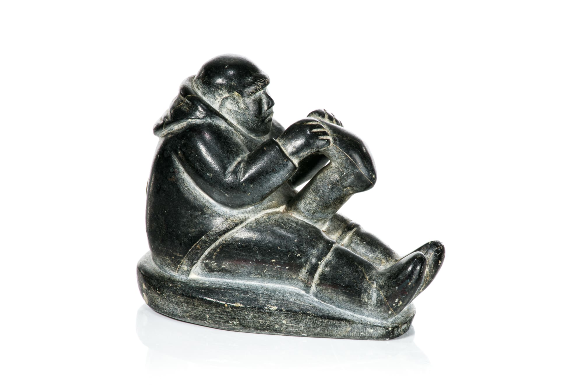 POOTOOGOOK, KINNGAIT (CAPE DORSET) Seated Man with Kamik, 1950s stone, 3.5 x 4.75 x 2.5 in (8.9 x 12.1 x 6.3 cm) $550
