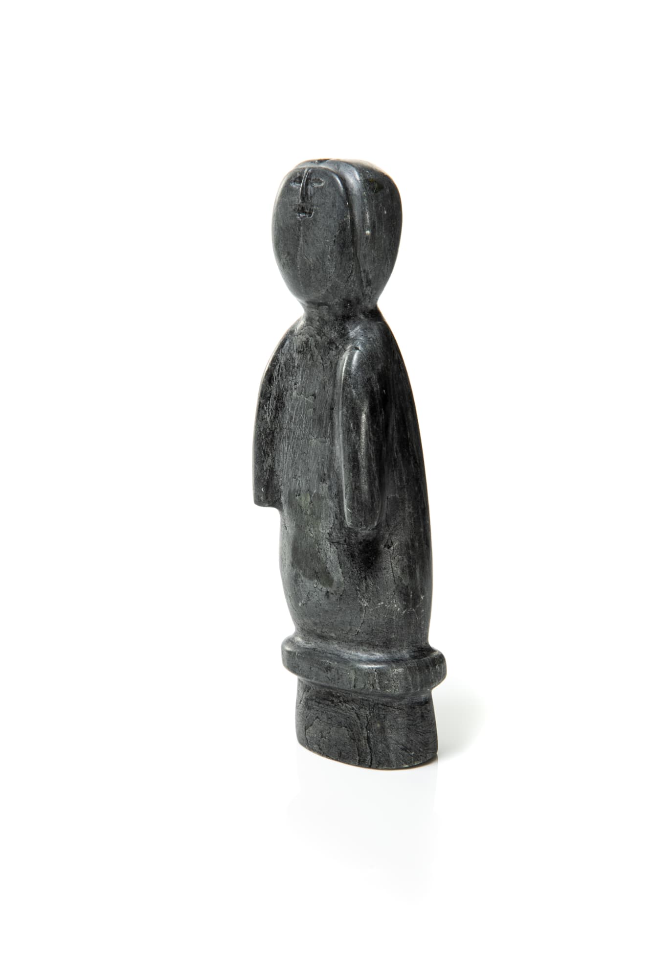 LOT 92 MELANIE, ARVIAT (ESKIMO POINT) Standing Figure stone, 6.25 x 1.75 x 1.25 in (15.9 x 4.4 x 3.2 cm) ESTIMATE: $150 — $250