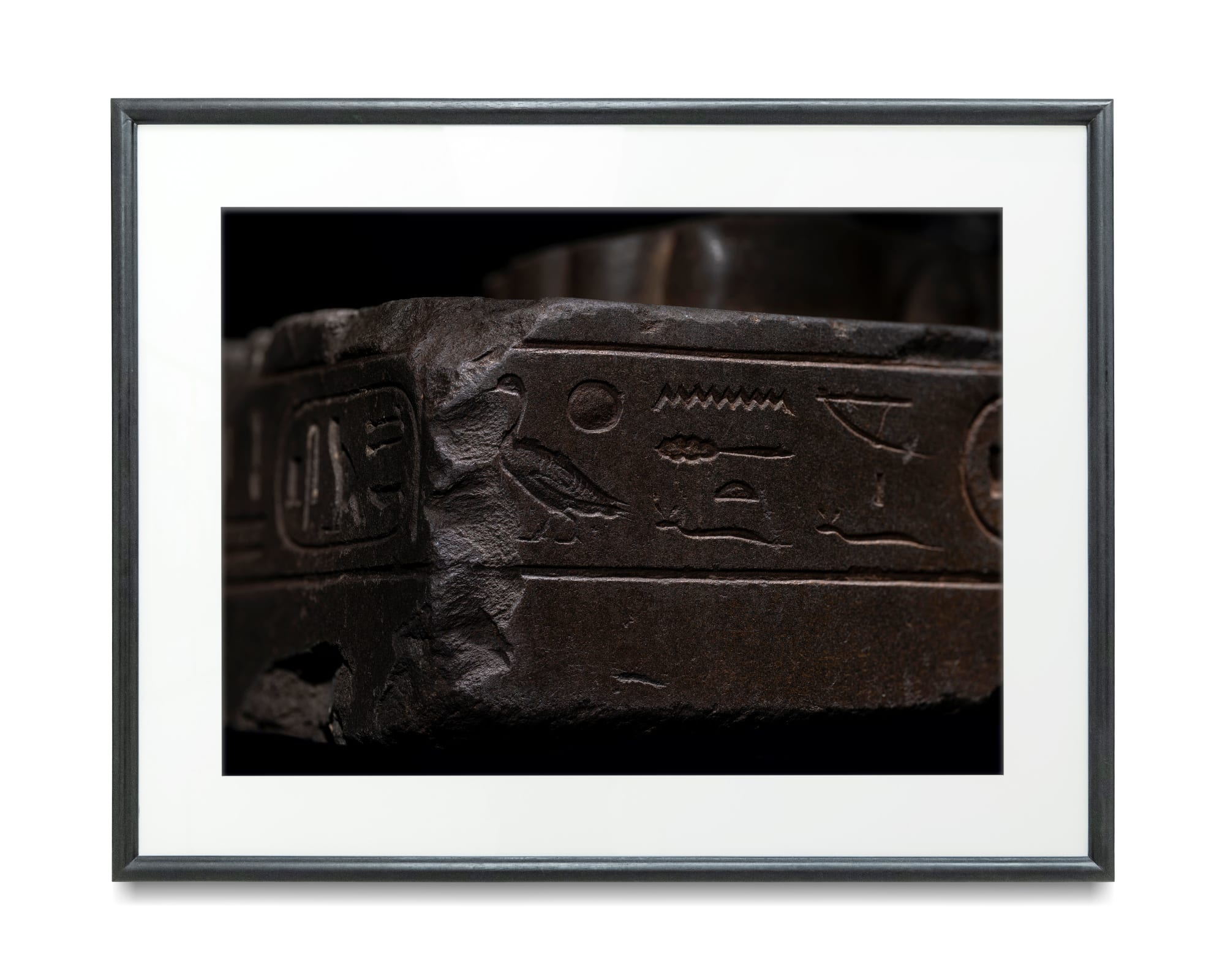 Jaron James, A photographic print of an Egyptian greywacke sphinx base, 2022