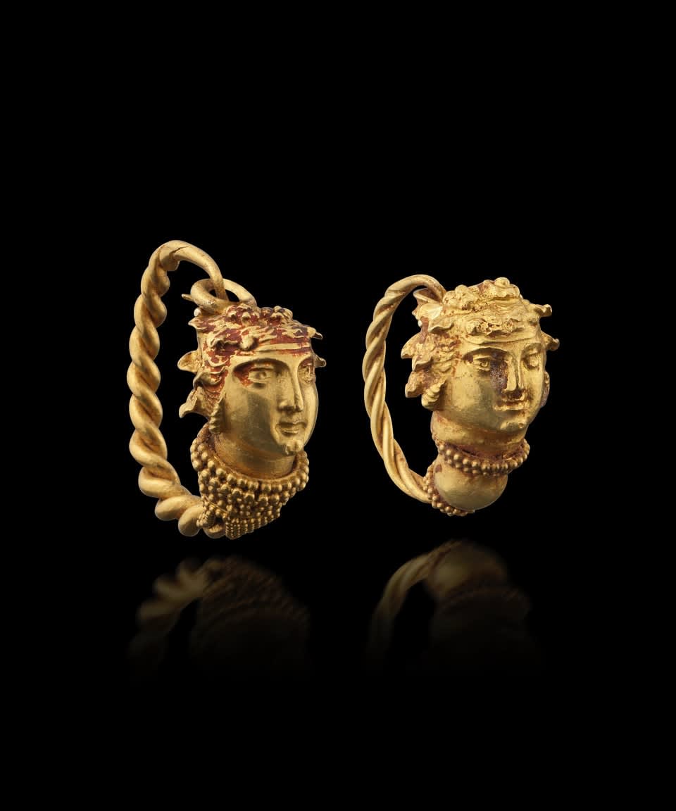 Greek, Two Greek gold earrings in the form of Maenad heads, Hellenistic, circa 4th - 3rd century BC