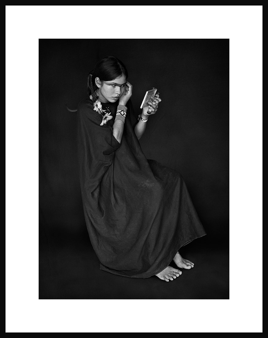 Sebastião Salgado, Luísa, daughter of Moisés Piyãko Asháninka, paints herself in the mirror. Kampa do Rio Amônea Indigenous Territory, state of Acre, 2016