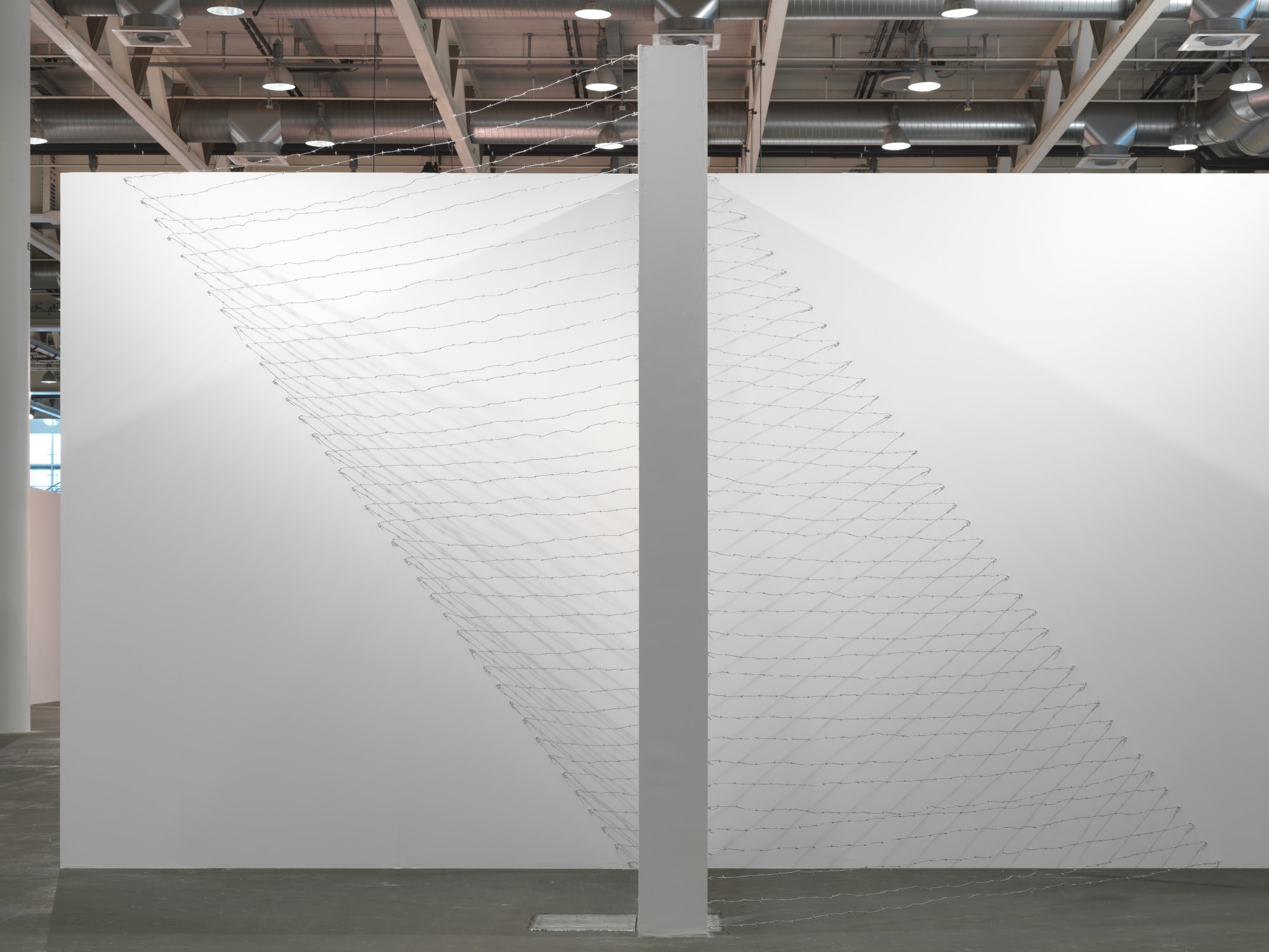 Installation view: Melvin Edwards: Pyramid Up and Down Pyramid ( (1969/2012), Barbed wire, dimensions variable, Alexander Gray Associates, Art Unlimited Art 43 Basel, 2012