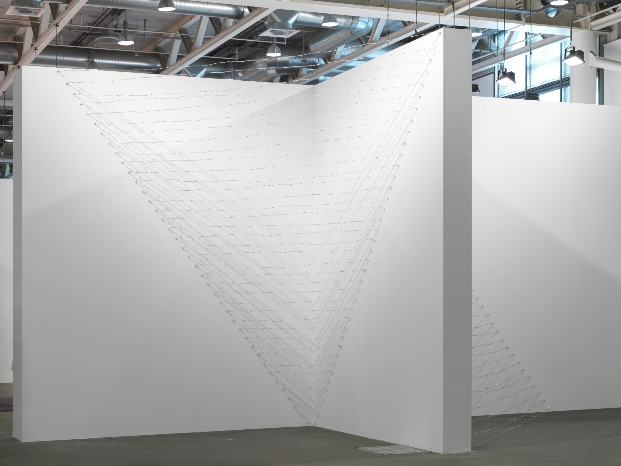 Installation view: Melvin Edwards: Pyramid Up and Down Pyramid ( (1969/2012), Barbed wire, dimensions variable, Alexander Gray Associates, Art Unlimited Art 43 Basel, 2012