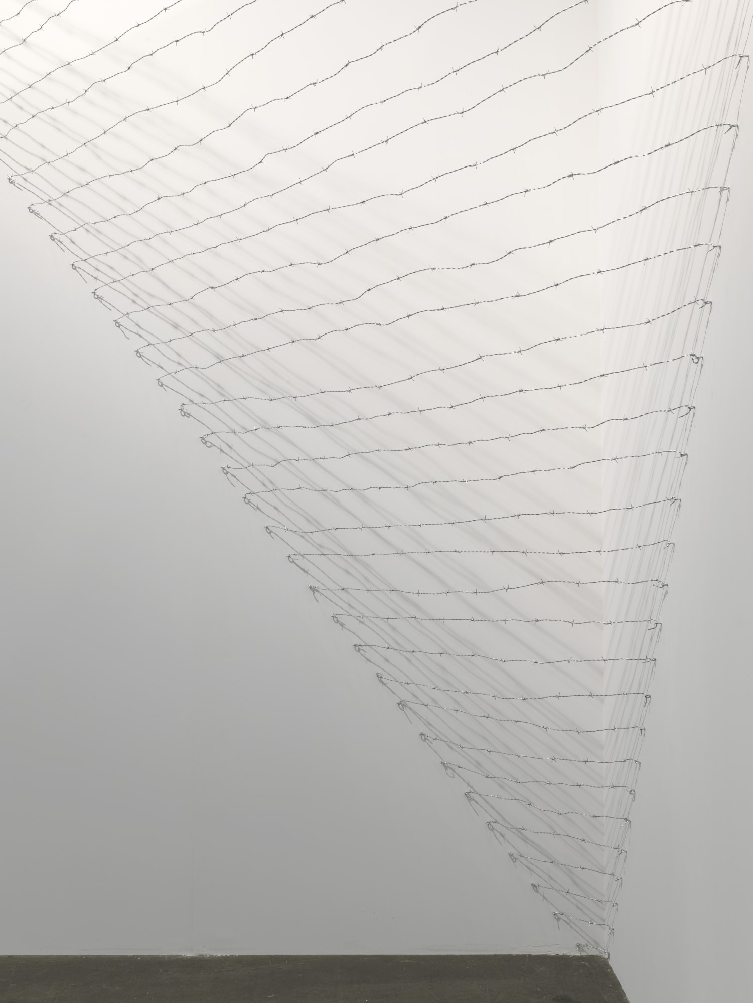 Installation view: Melvin Edwards: Pyramid Up and Down Pyramid ( (1969/2012), Barbed wire, dimensions variable, Alexander Gray Associates, Art Unlimited Art 43 Basel, 2012