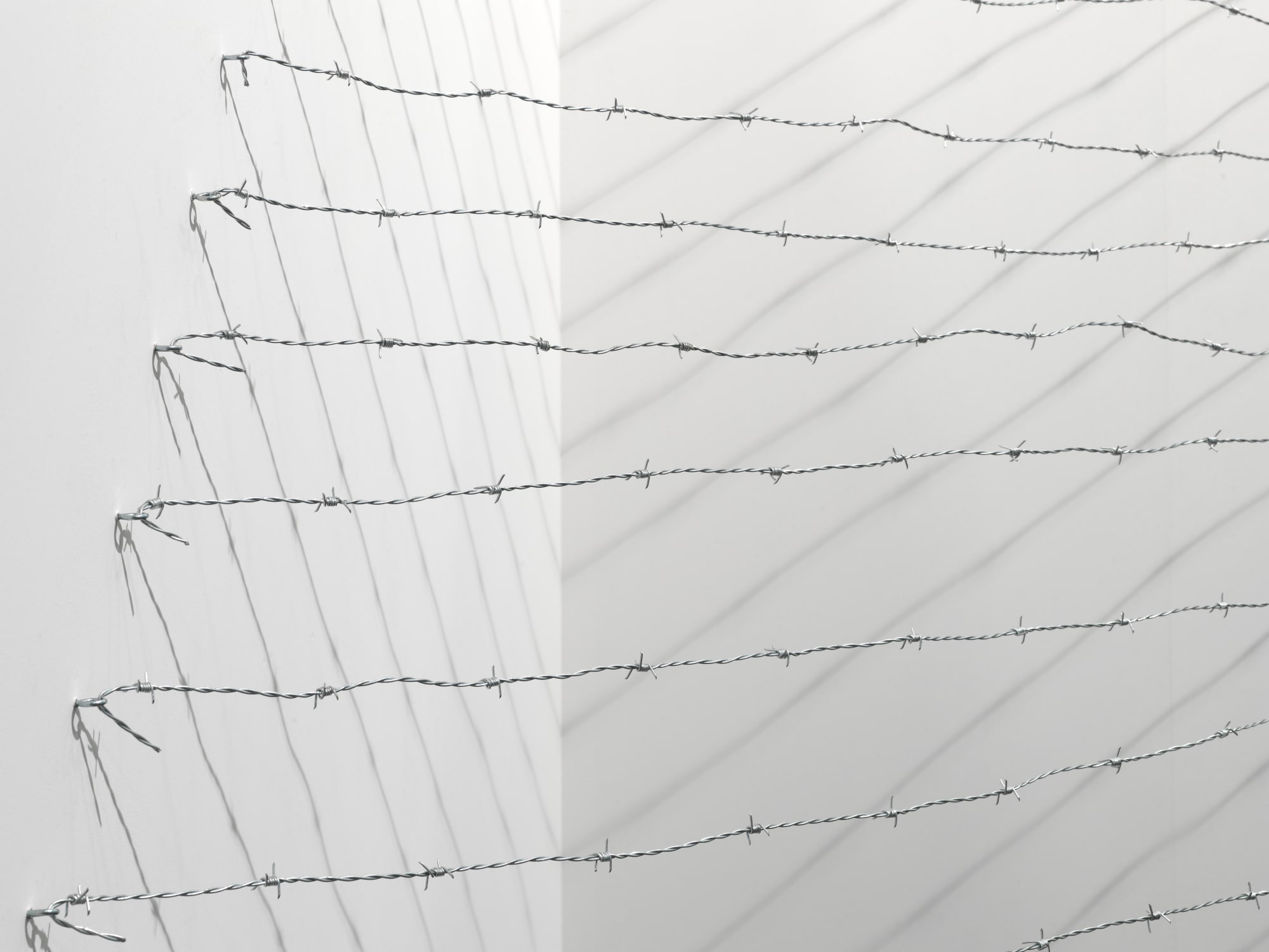 Installation view: Melvin Edwards: Pyramid Up and Down Pyramid ( (1969/2012), Barbed wire, dimensions variable, Alexander Gray Associates, Art Unlimited Art 43 Basel, 2012