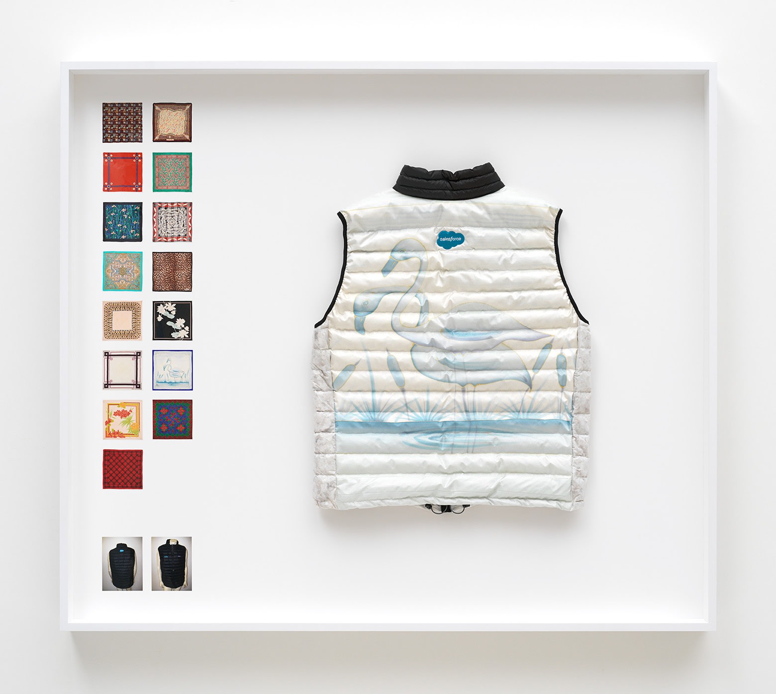 Simon Denny Power Vest 4, 2019 Scarf formerly owned by Margaret Thatcher, Patagonia M's Down Sweater Vest parts, Down sourced from second hand San Francisco garments, Ripstop Nylon, Salesforce and Quip embroidered logos, wood, glass, photo paper, cardboard 52 3/4 x 60 1/4 x 9 1/8 in 134 x 153 x 23 cm