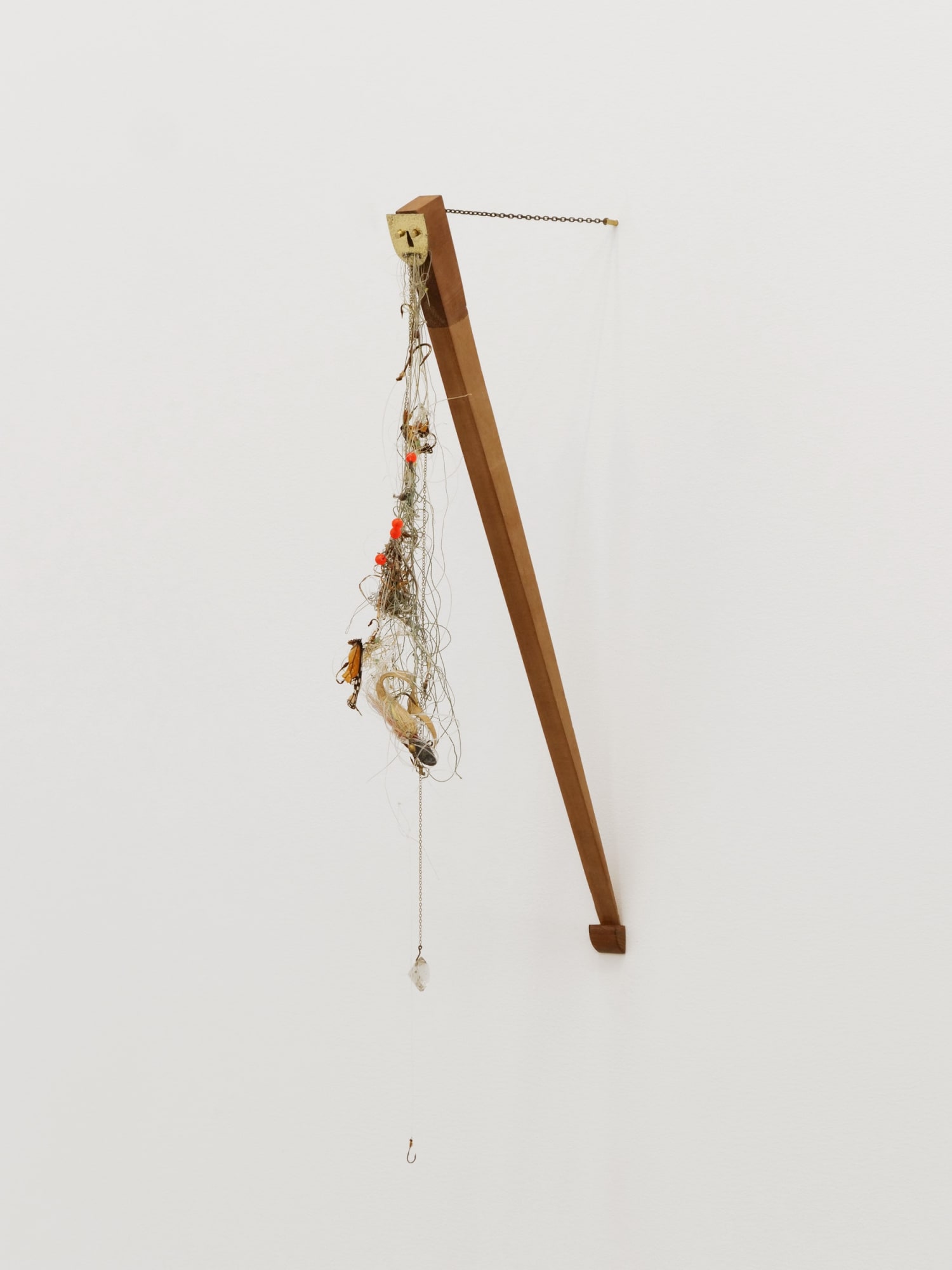 Will Rogan Self-portrait as the part of the door that needed to be removed so the door can close, 2018 Brass, wood, fishing line, hooks, butterfly wings, flotsom 28 x 4 x 11 1/2 in 71.1 x 10.2 x 29.2 cm