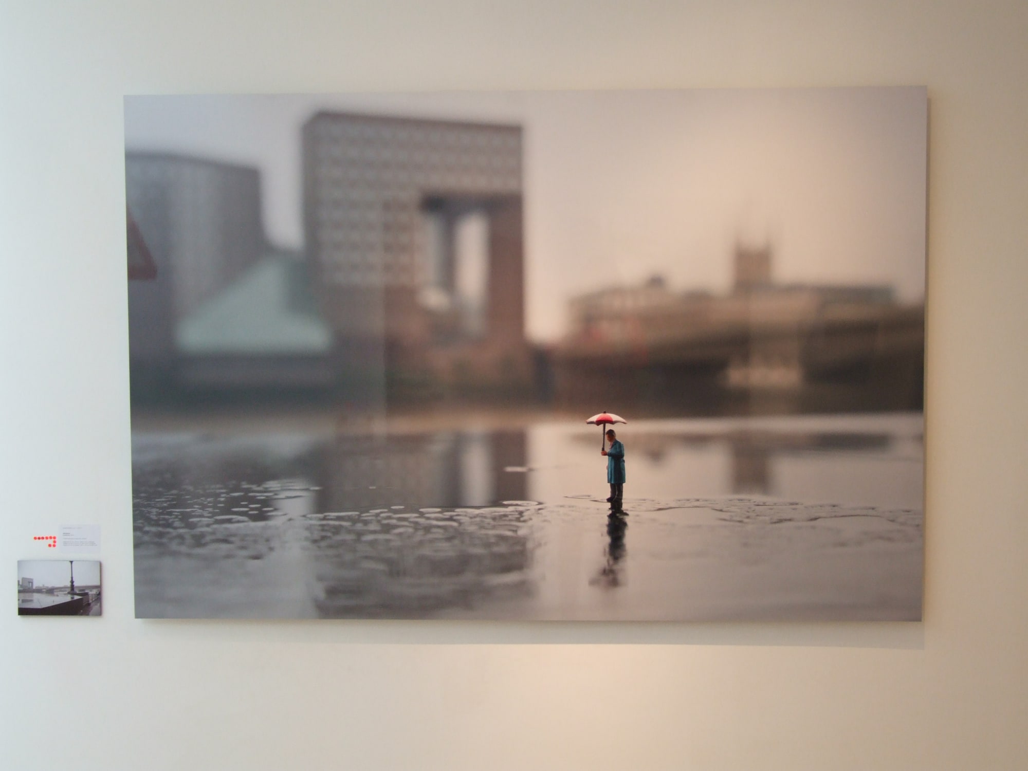 Slinkachu print hanging in exhibition.