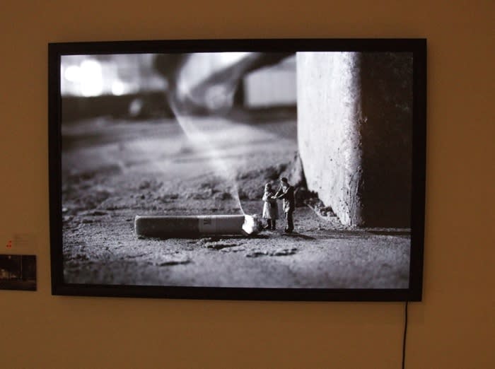 Slinkachu print hanging in exhibition.