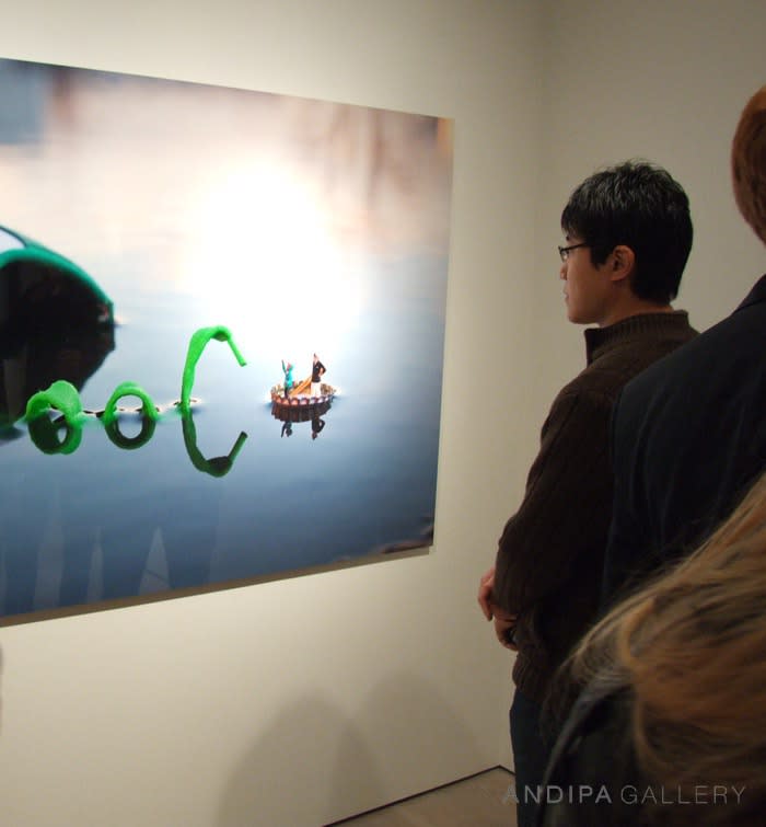 people looking at Slinkachu print hanging in exhibition at andipa gallery.