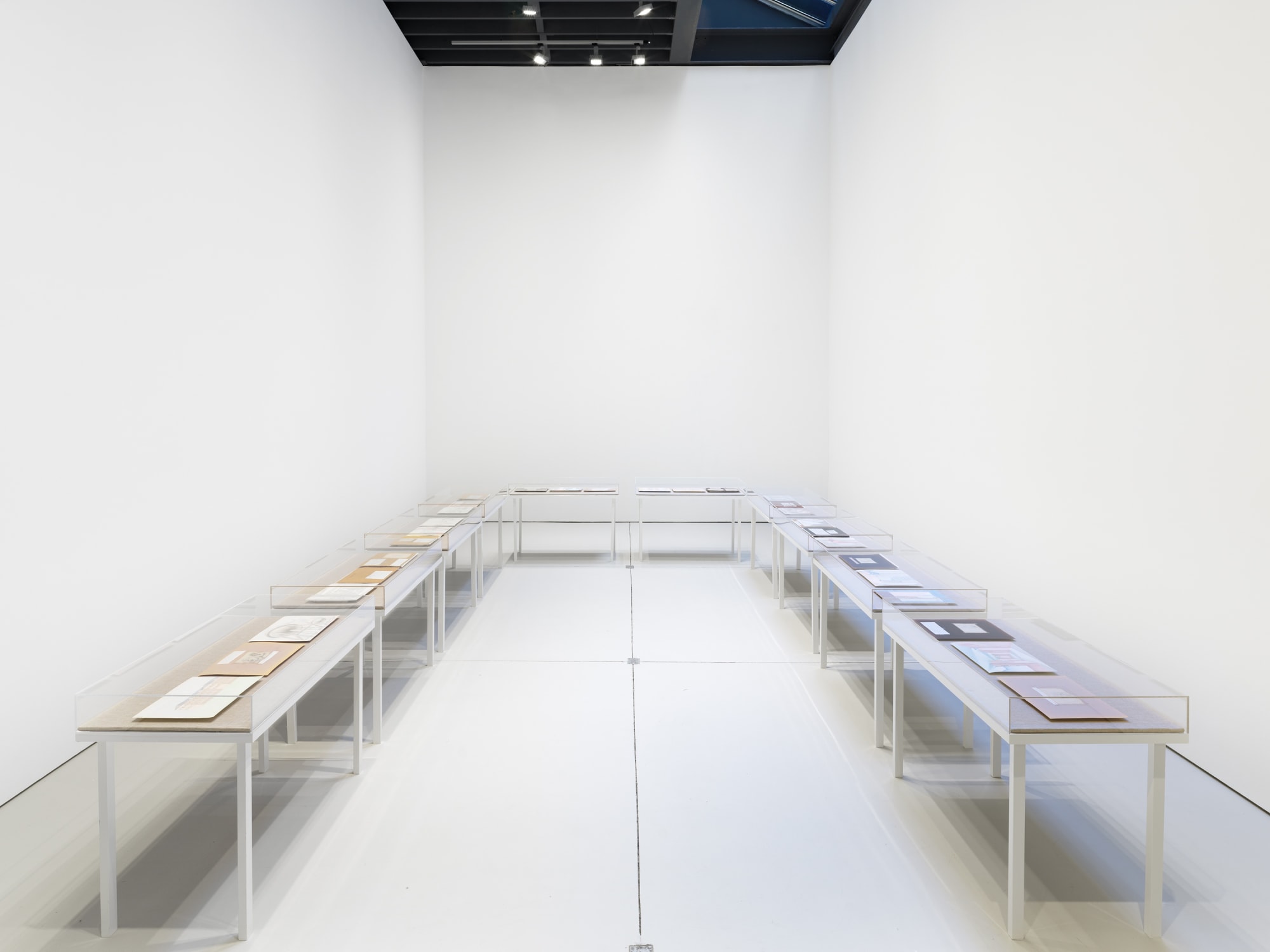 Installation view of David Byrd's exhibition on the first and second floors of the gallery. This image presents many of Byrd's observational drawings filed in a U-shaped display case.