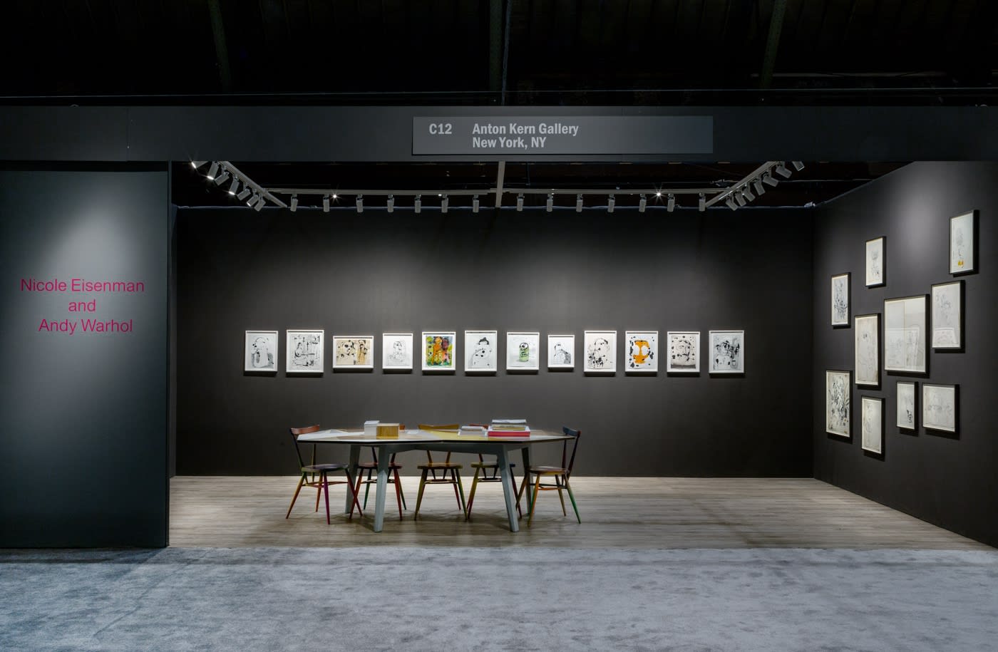 Nicole Eisenman and Andy Warhol dual booth at ADAA. Dark walls populated with drawings by the two artists.