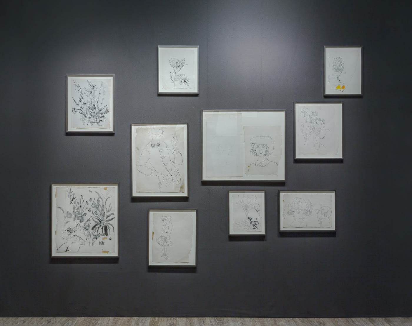 Nicole Eisenman and Andy Warhol dual booth at ADAA. Dark walls populated with drawings by the two artists.