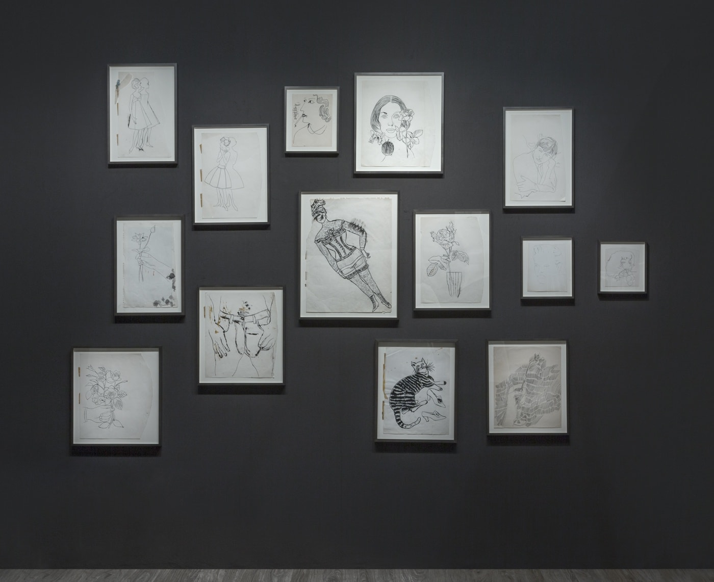Nicole Eisenman and Andy Warhol dual booth at ADAA. Dark walls populated with drawings by the two artists.