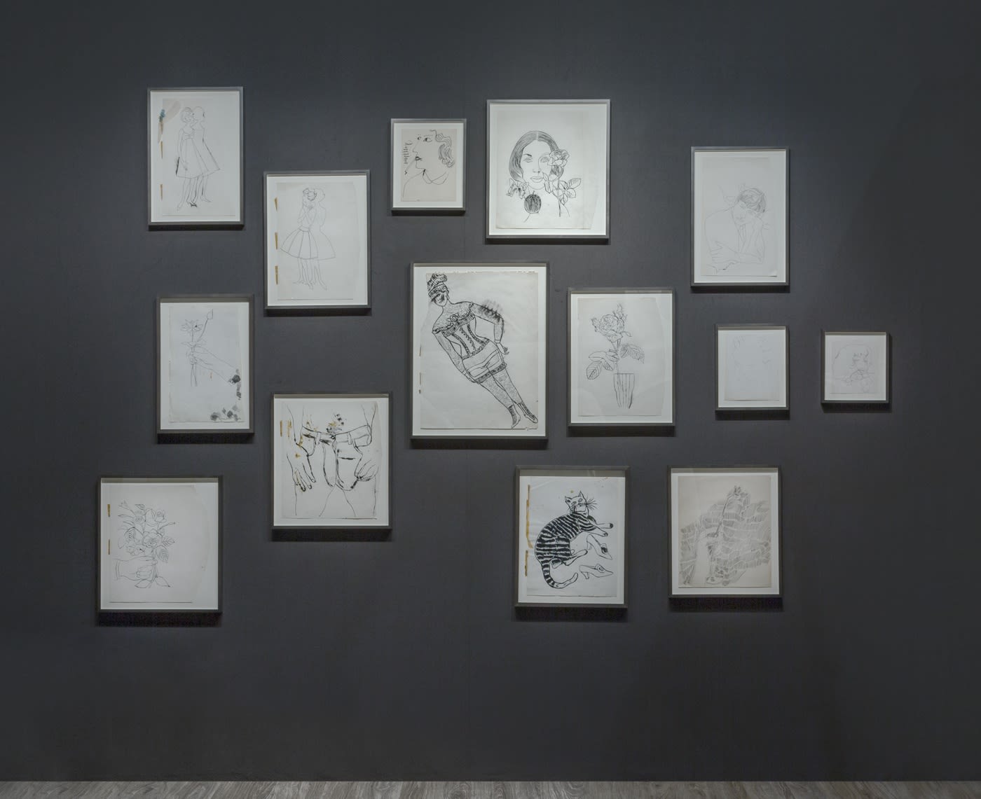 Nicole Eisenman and Andy Warhol dual booth at ADAA. Dark walls populated with drawings by the two artists.
