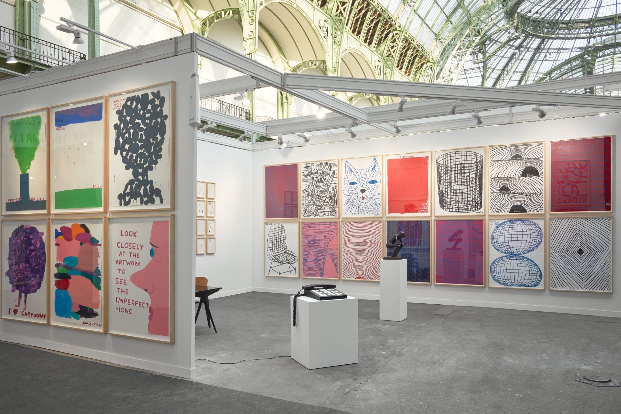 Solo booth of colorful David Shrigley paintings and sculptures.