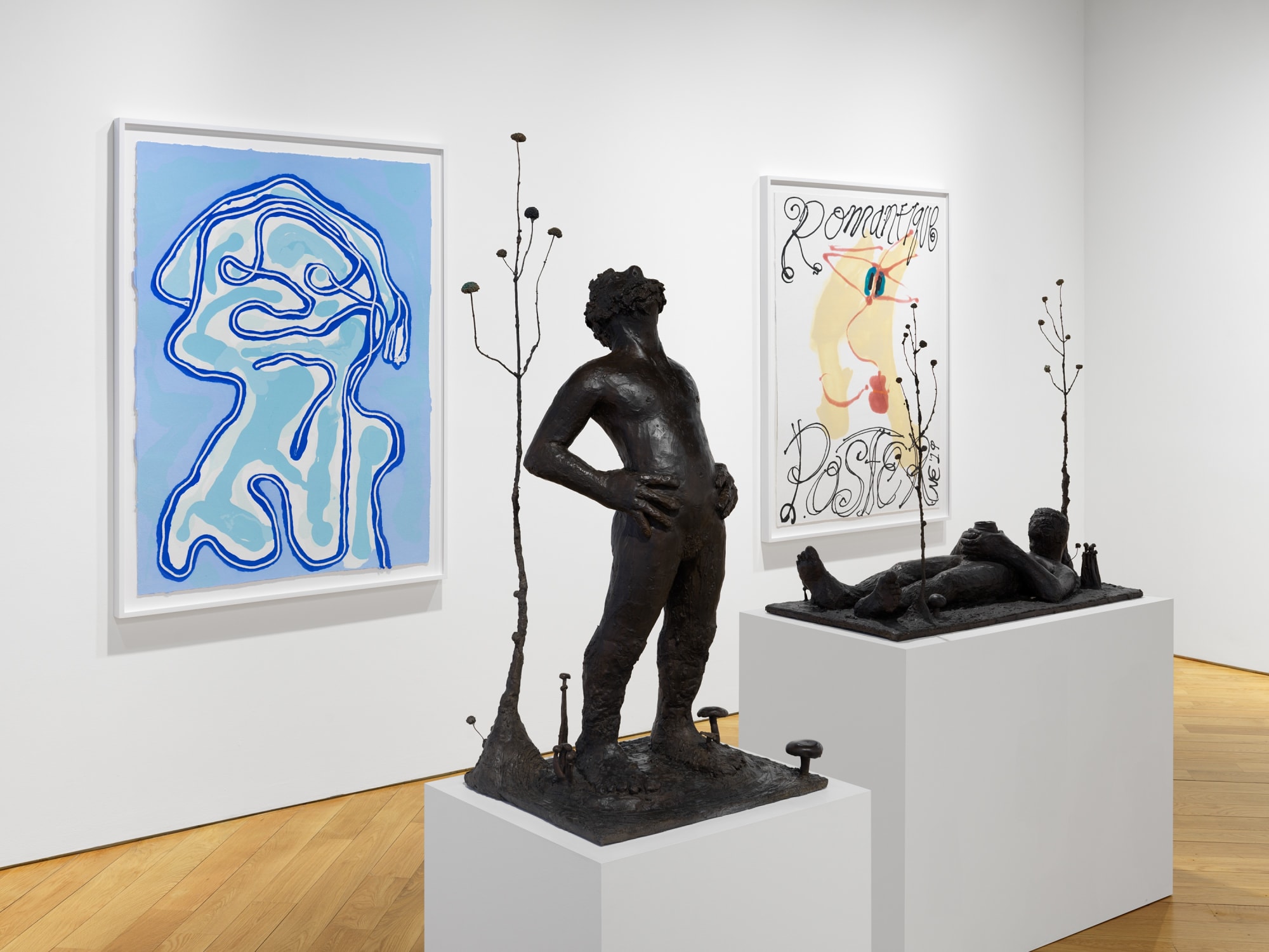 Installation view of Nicole Eisenman's exhibition at the gallery in early 2021 of maquettes and prints. Two sculptures and two prints featured.