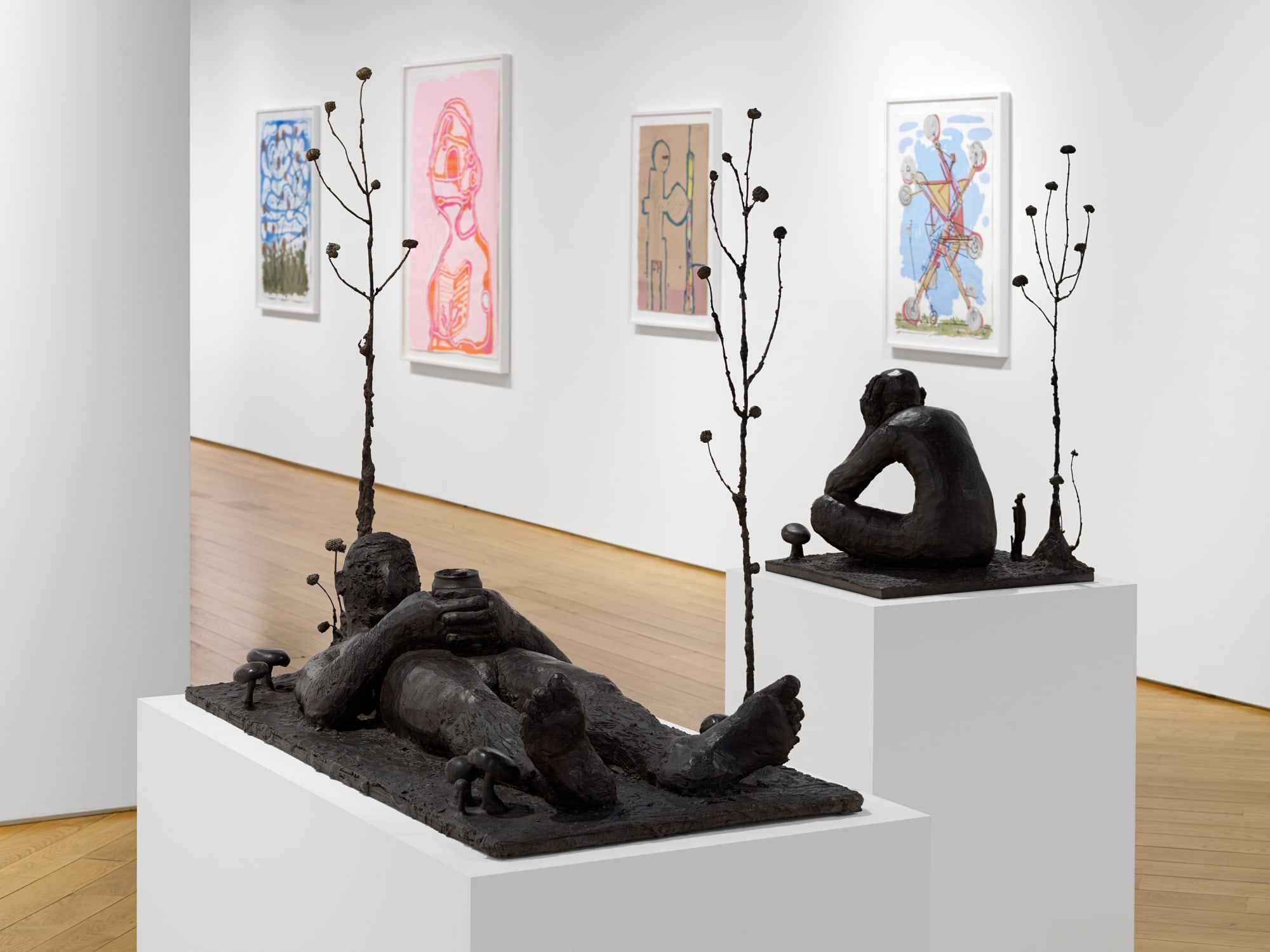 Installation view of Nicole Eisenman's exhibition at the gallery in early 2021 of maquettes and prints. Shot of a few prints and two sculptures.