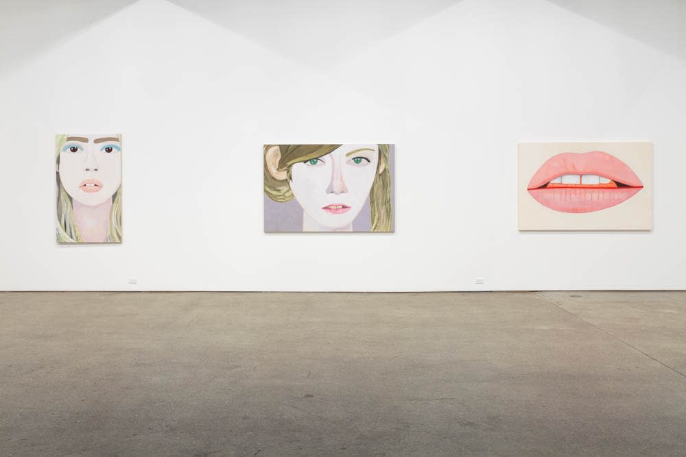 Installation view of Brian Calvin's fourth show at Anton Kern Gallery, featuring a group of paintings of faces, lips, mouths, poses, and a mirror. Three works featured.