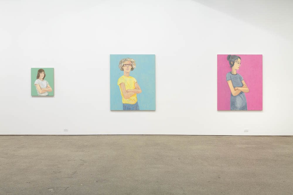 Installation view of Brian Calvin's fourth show at Anton Kern Gallery, featuring a group of paintings of faces, lips, mouths, poses, and a mirror. Three works featured in this view.