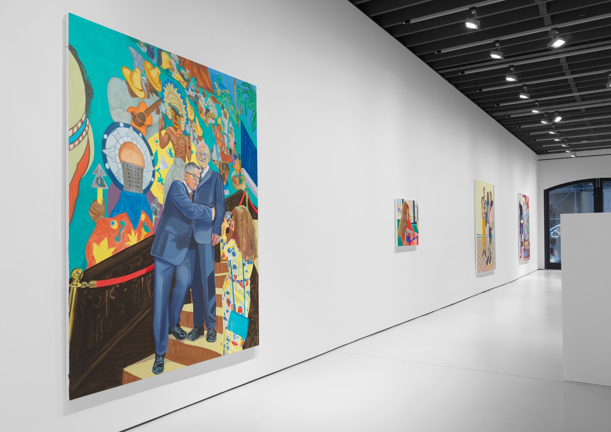 Installation view of Aliza Nisenbaum's solo exhibition of the gallery featuring large paintings. Painting titled "Alberto, David, y Aliza con mural de Roberto Cueva del Rio" alongside a smaller work.
