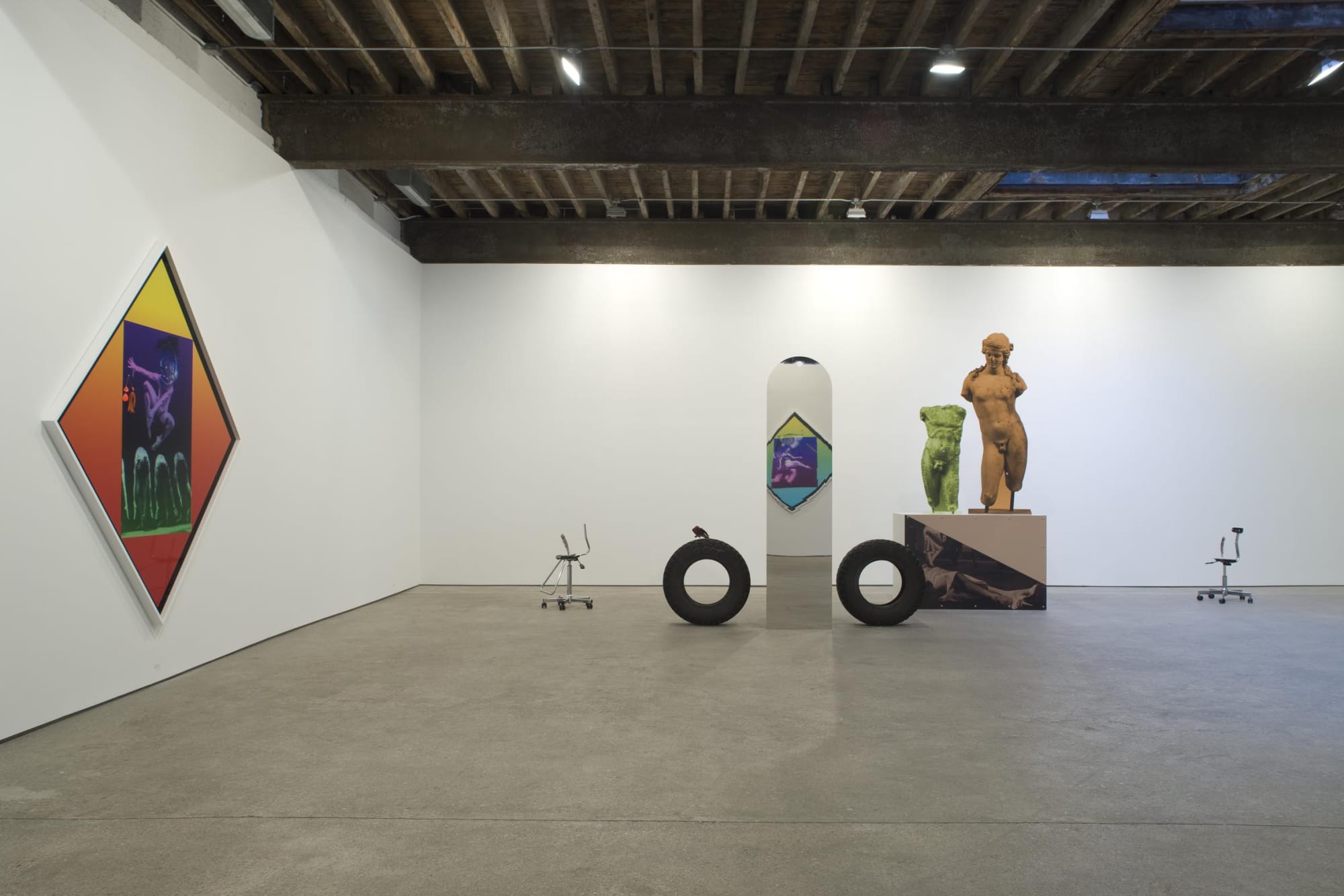 Installation view of Lothar Hempel's solo show, comprised of four figurative sculptures, three diamond photomontages, and one painting. A few works featured.