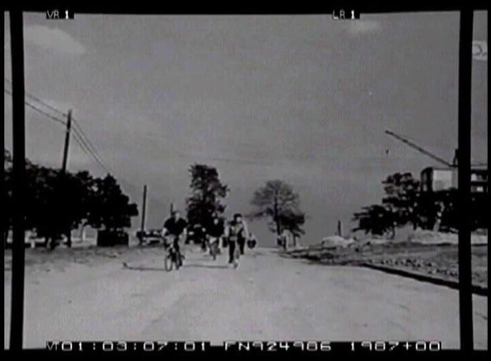 Installation view of Wihelm Sasnal's third solo exhibition at Anton Kern Gallery, consisting of a 16 mm film, a set of posters, and a group of a paintings. Another film still.