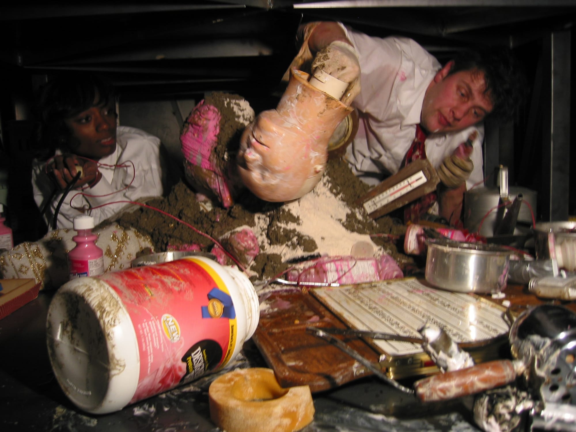 Installation view of the collaborative show from John Bock and Bendix Harms. Still from Bock performing within his metal sculpture.