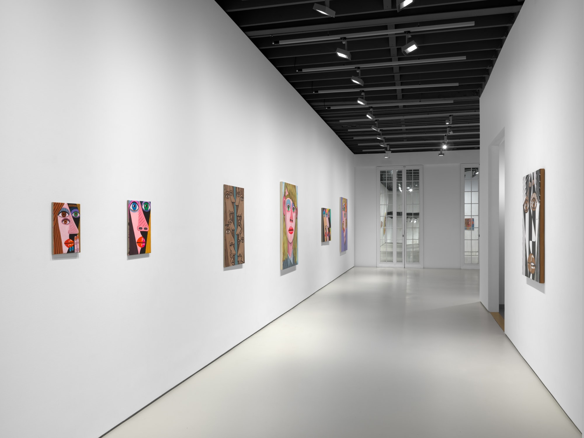 installation view of Brian Calvin's Waiting featuring paintings with hyperbolic color, mosaic eyes, and more. Many works shown.