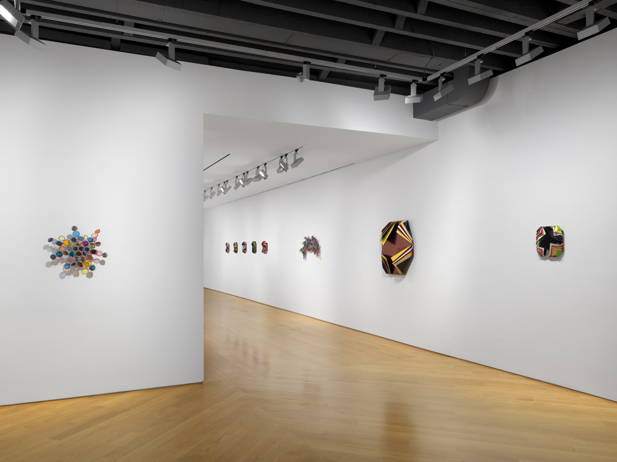 Installation view of Jim Lambie's works on the 3rd floor of the gallery featuring many works.