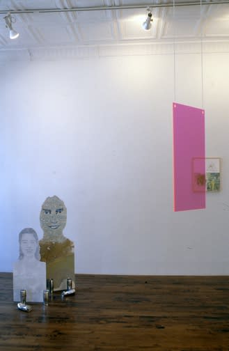 Installation view of Lothar Hempel's show titled "America Disappears Only the Smile Remains," featuring plexiglass works, wood cutouts, and other photocollages. Two works featured.