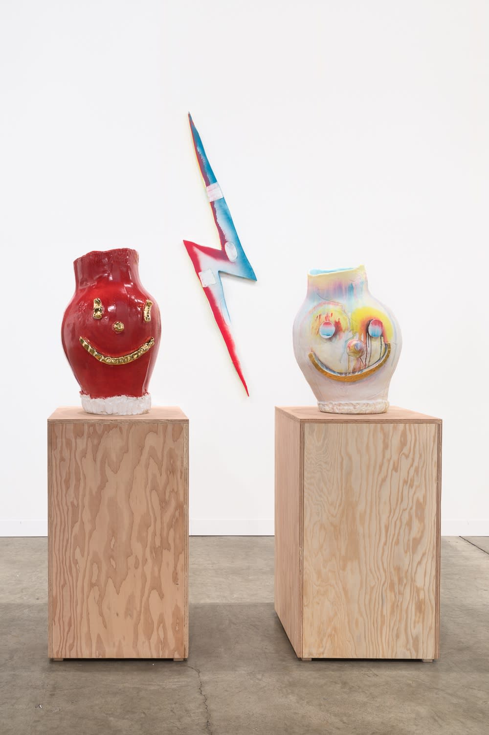 Installation view of Art Basel Miami 2015. Two McCarthy faces frame a Lothar piece.