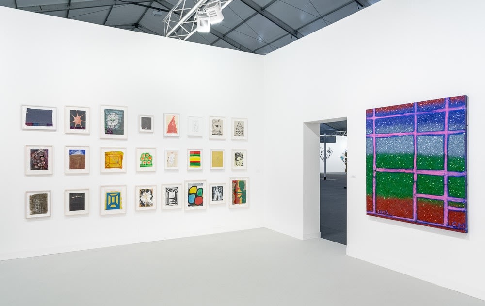 Installation view of Chris Martin's solo exhibition at Frieze London 2015. Small-scale works and a medium-scale painting featured.