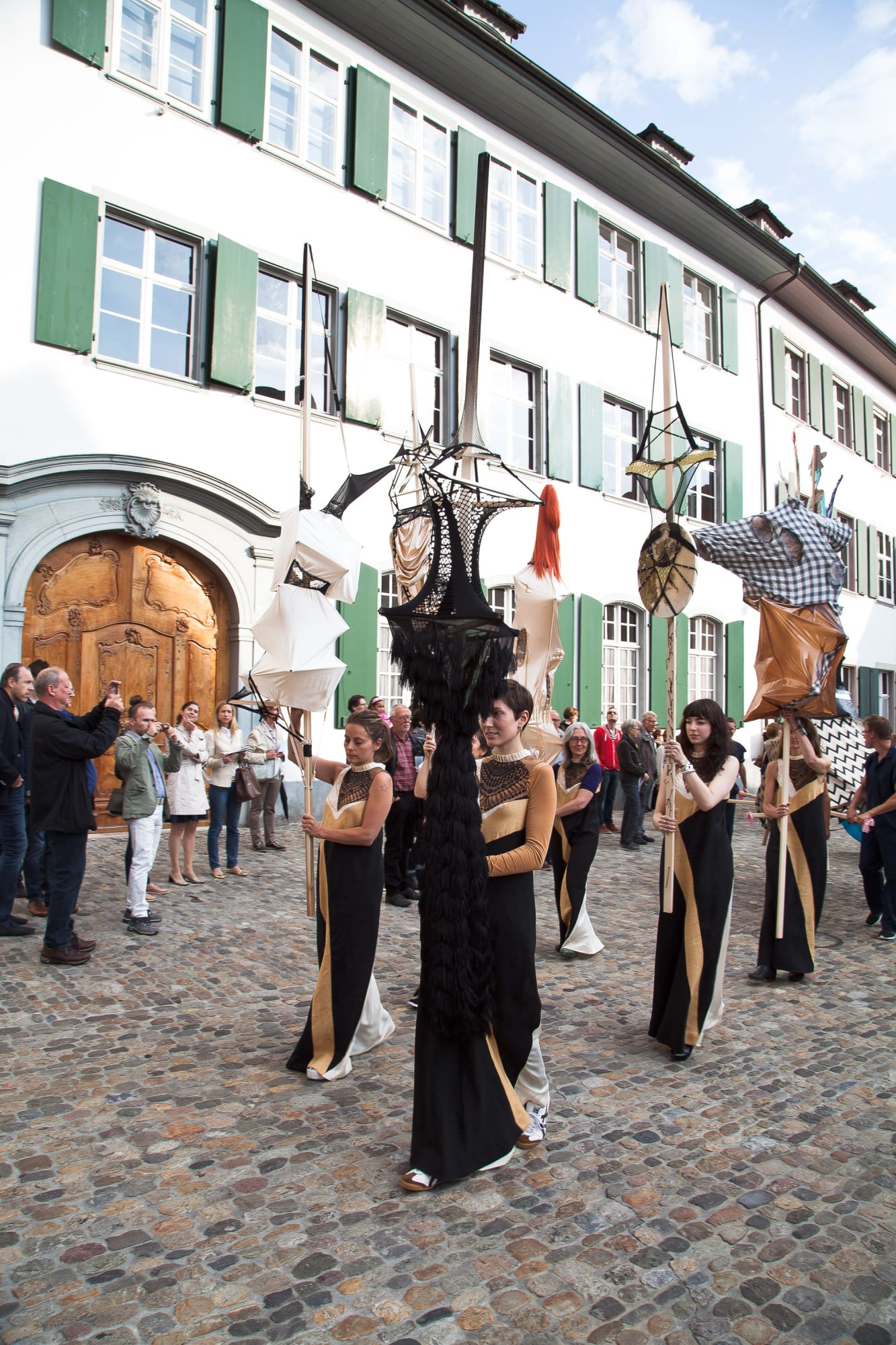 Installation view of Lara Schnitger's show at Basel Parcours, featuring a large body of works as well as a procession through Mezzeplatz. Schnitger's works held high during the procession.
