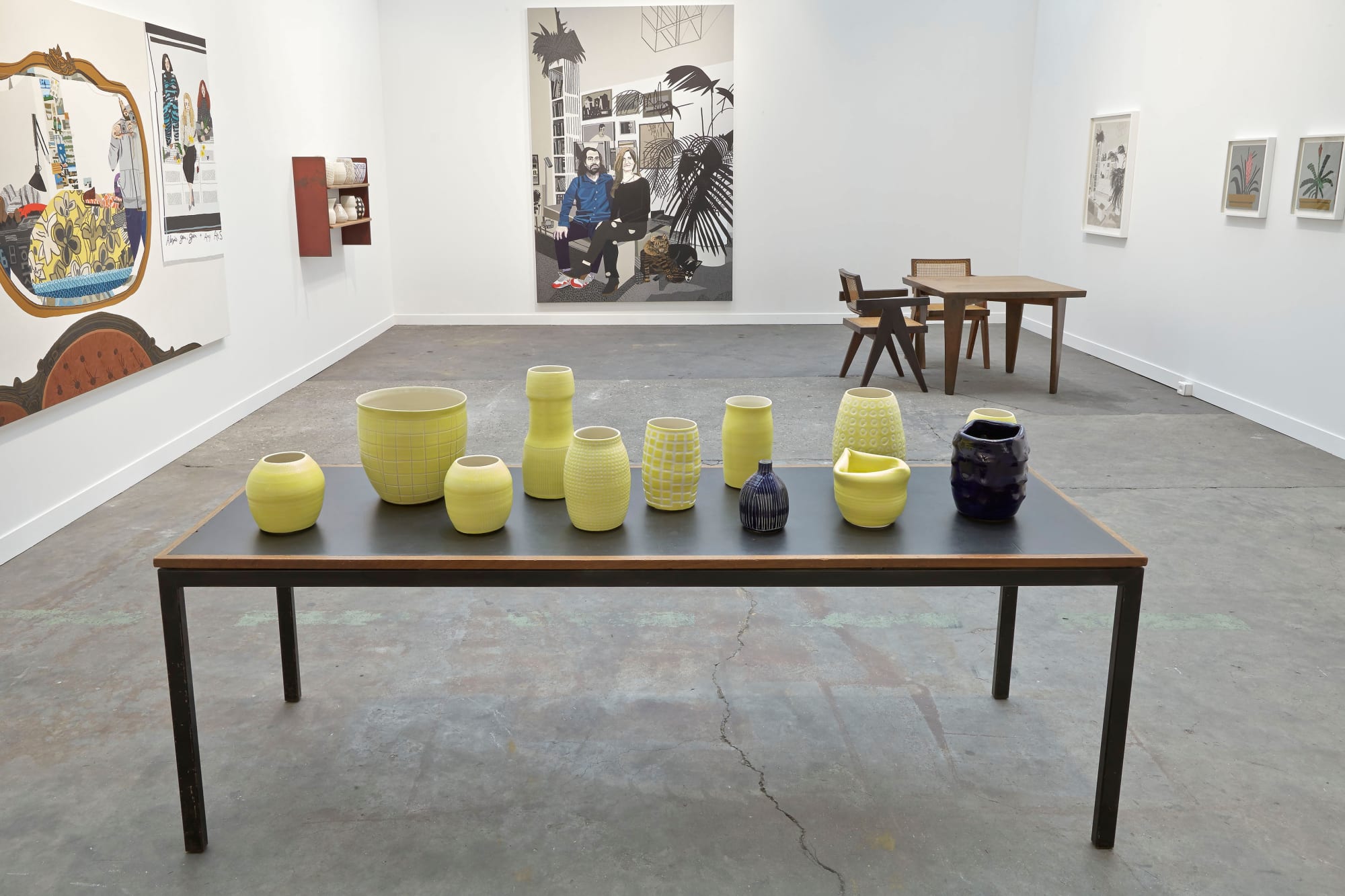 Installation view of Anton Kern Gallery's booth at FIAC 2014 featuring ceramics from Shio Kusaka and painted works by Jonas Wood. Detailed shot of Kusaka's pots with Wood's Brian and Ana in the background.