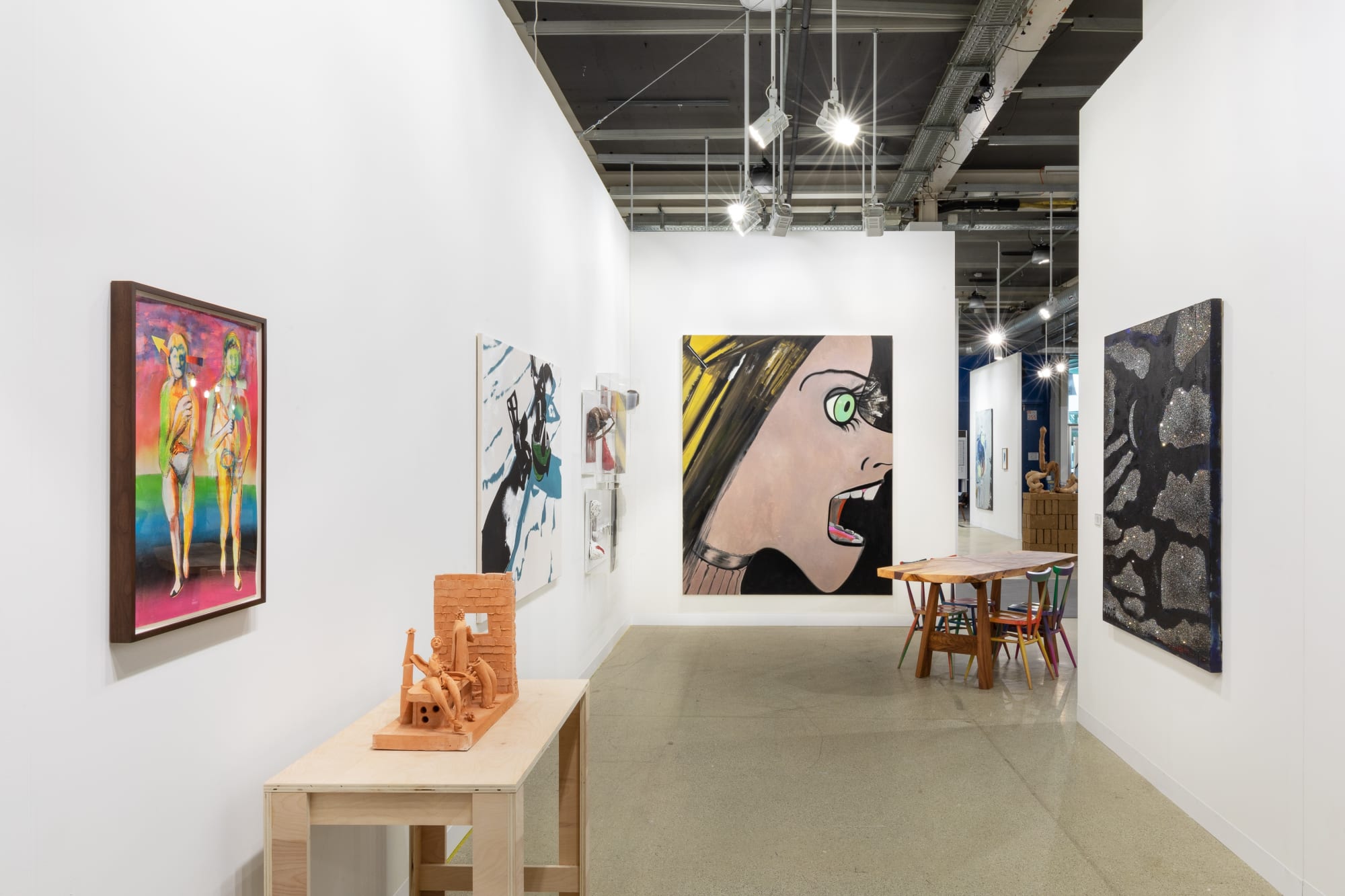 Installation view of Art Basel featuring the majority of works in the both, including sculptures, paintings, and more.