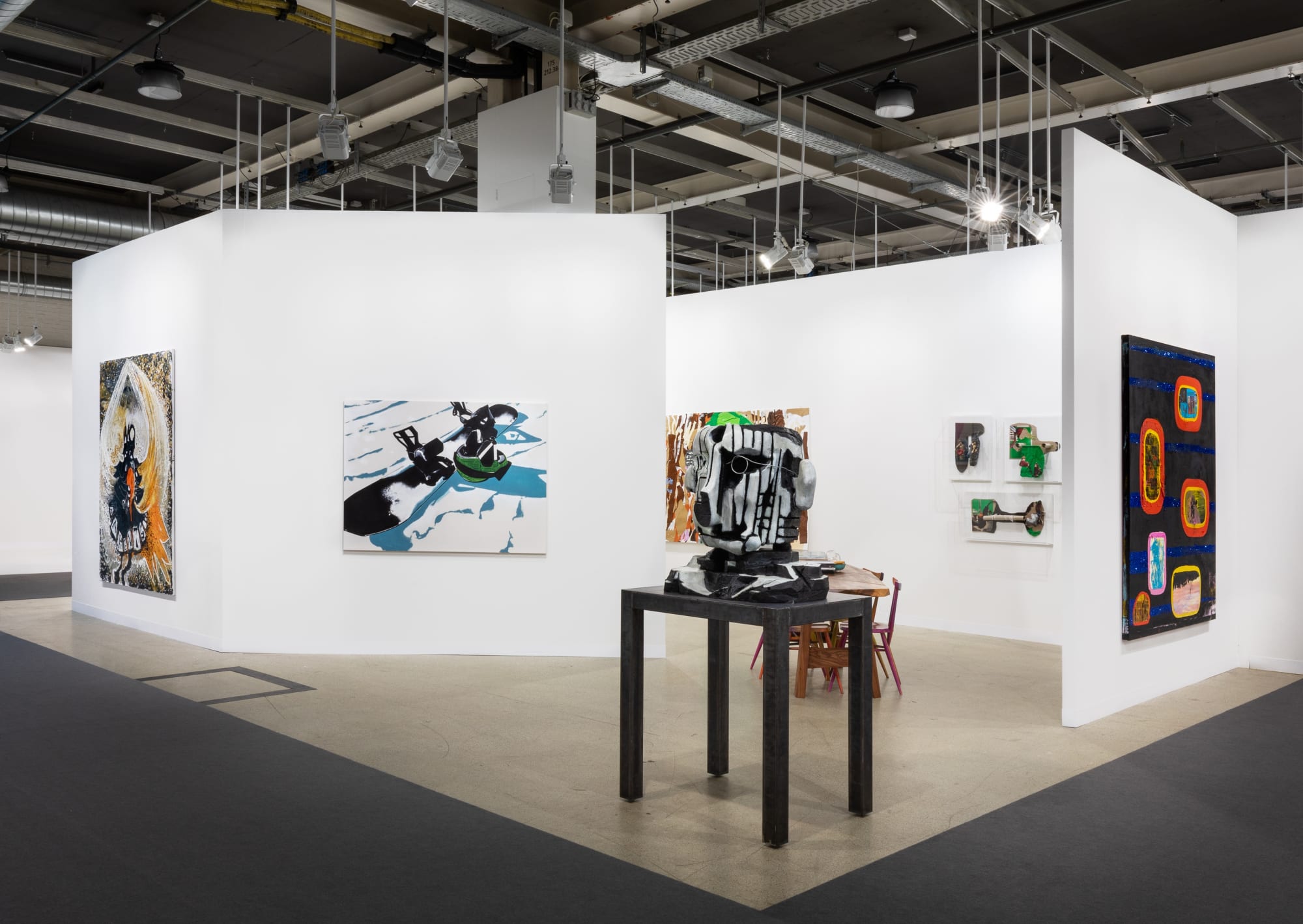 Installation view of Art Basel featuring the majority of works in the both, including sculptures, paintings, and more.
