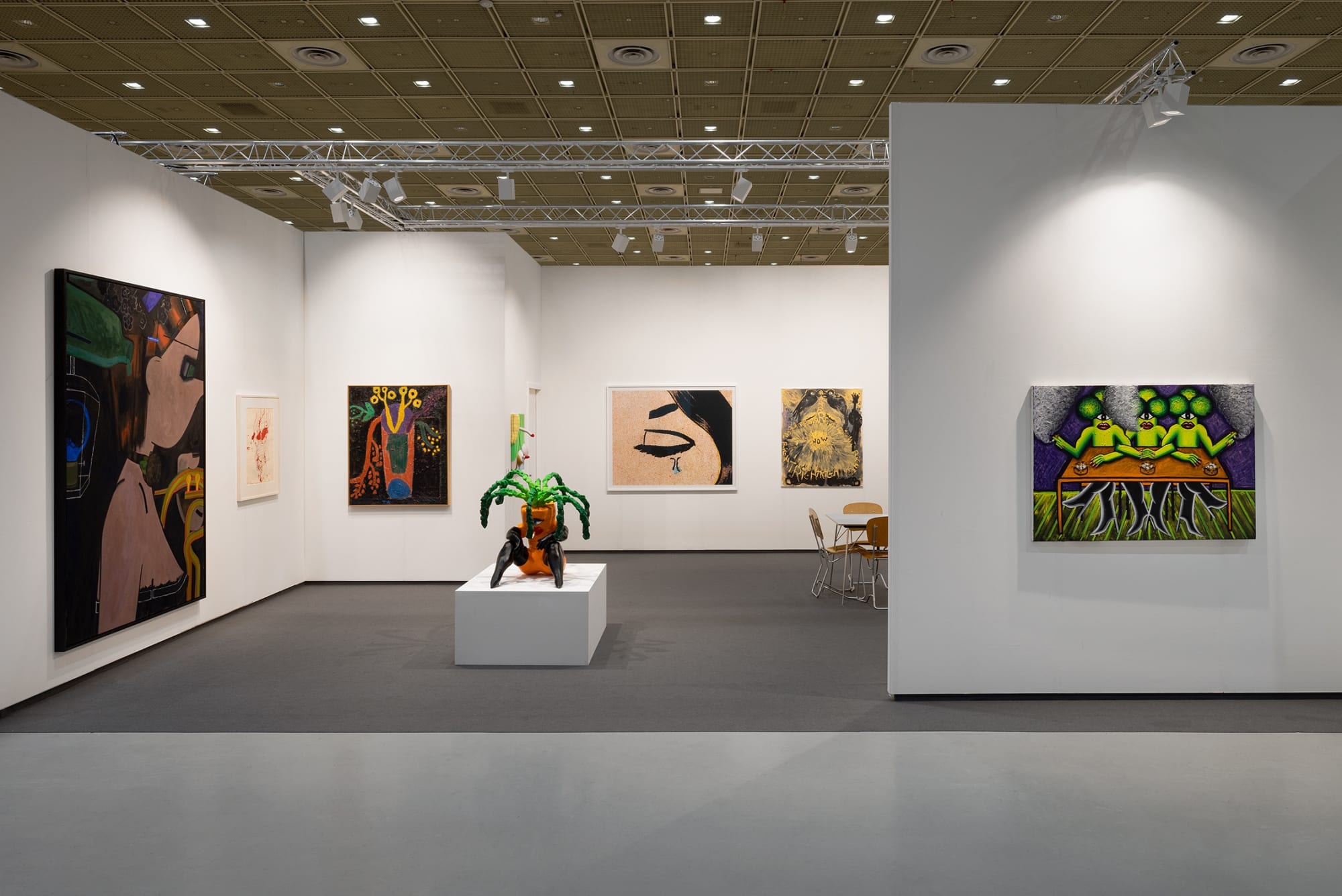 Installation view of Anton Kern Gallery booth at Frieze Seoul with white walls, dark floors, pedestal, sculpture, and paintings