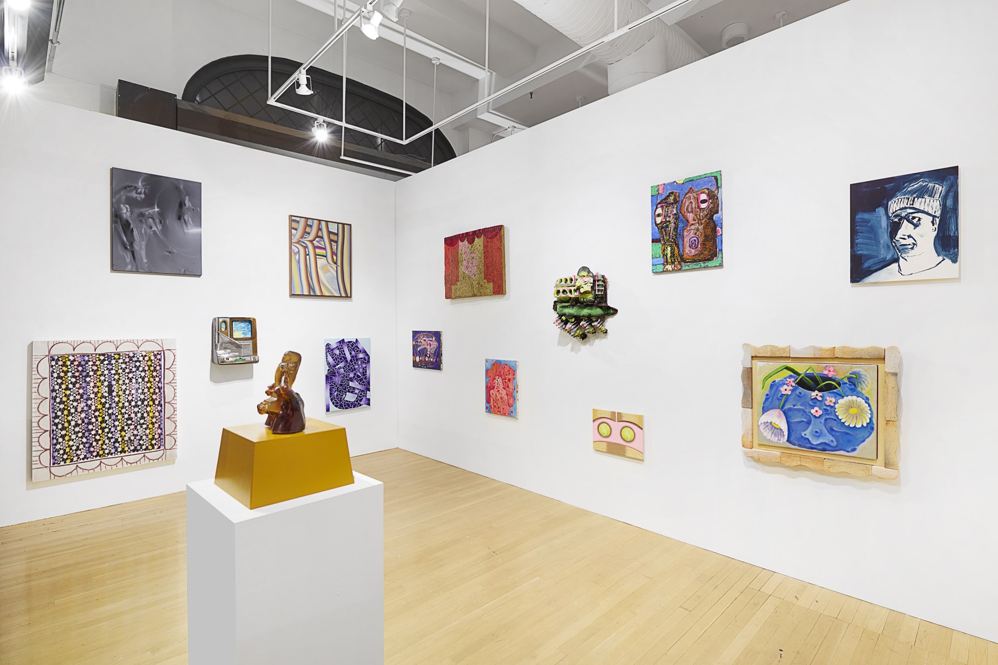 Installation view of the 2023 exhibition “Friends & Family” with view of wood floors, walls, artworks and ceiling.
