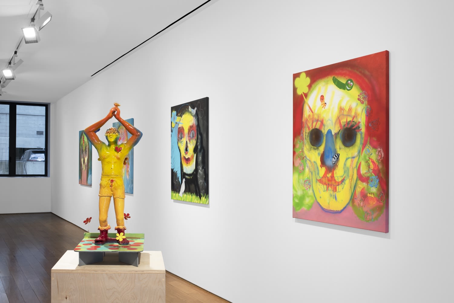 Installation view of the 2023 exhibition “Alessandro Pessoli: Pluto is my Master” with view of wood floors, walls, artworks and ceiling.