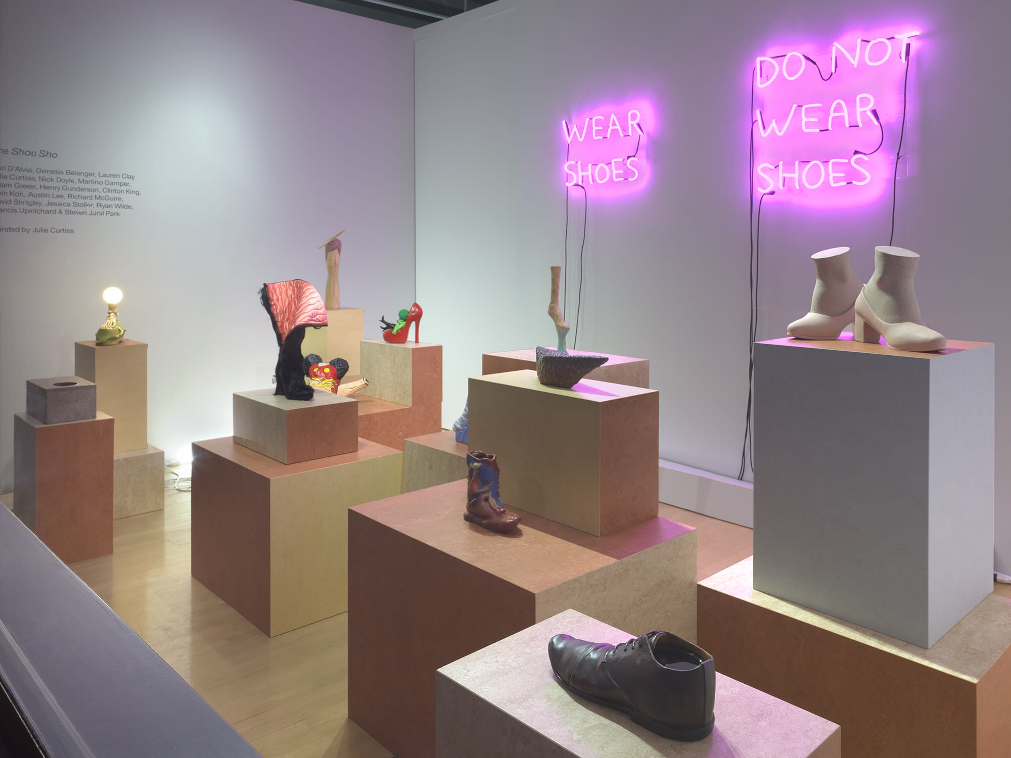 Installation view at WINDOW-Walker side close-up majority of shoes pictured. At an angle. Clinton's shoe visible in lower right corner.