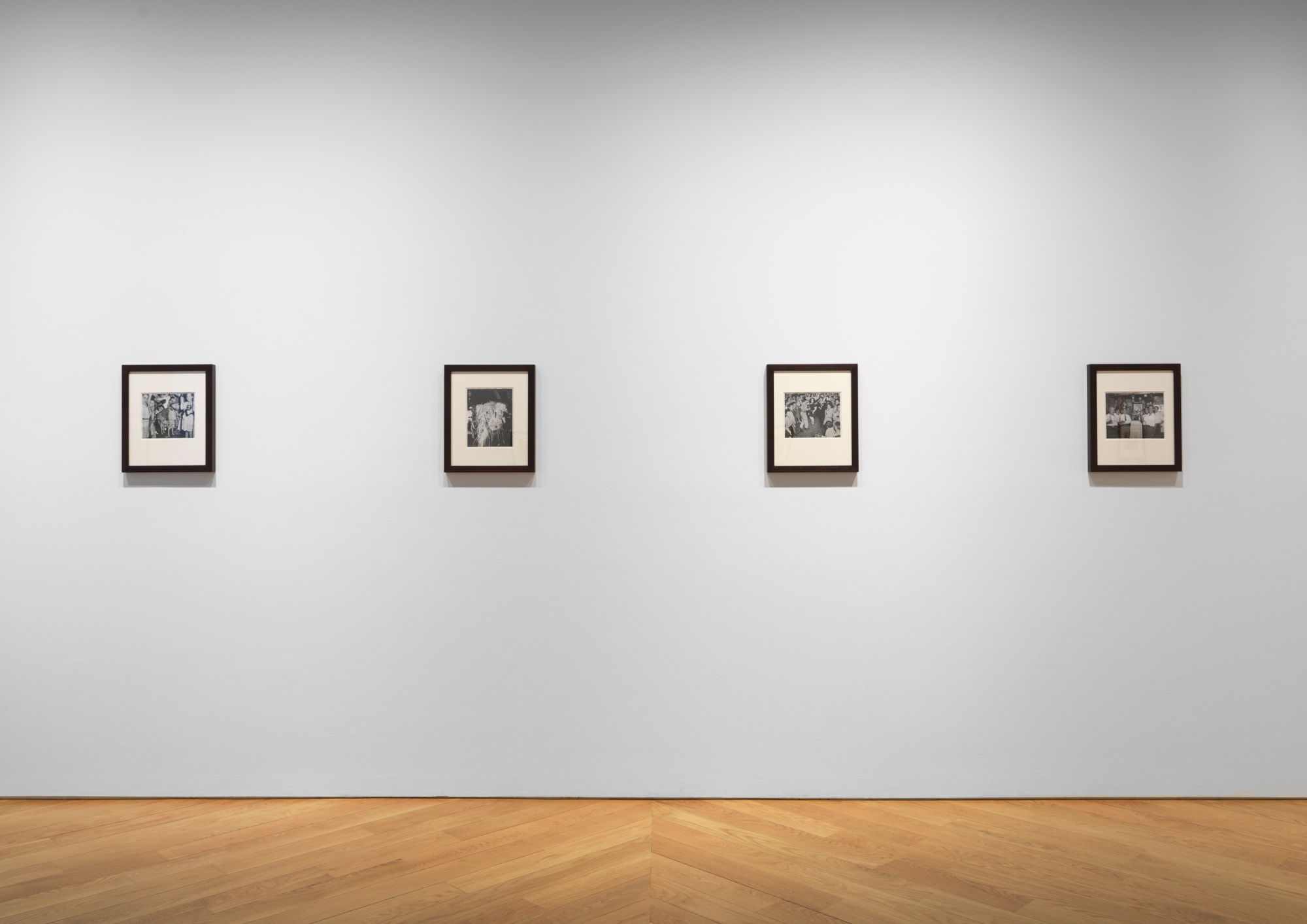 Installation view of Weegee photos, featuring a few works.