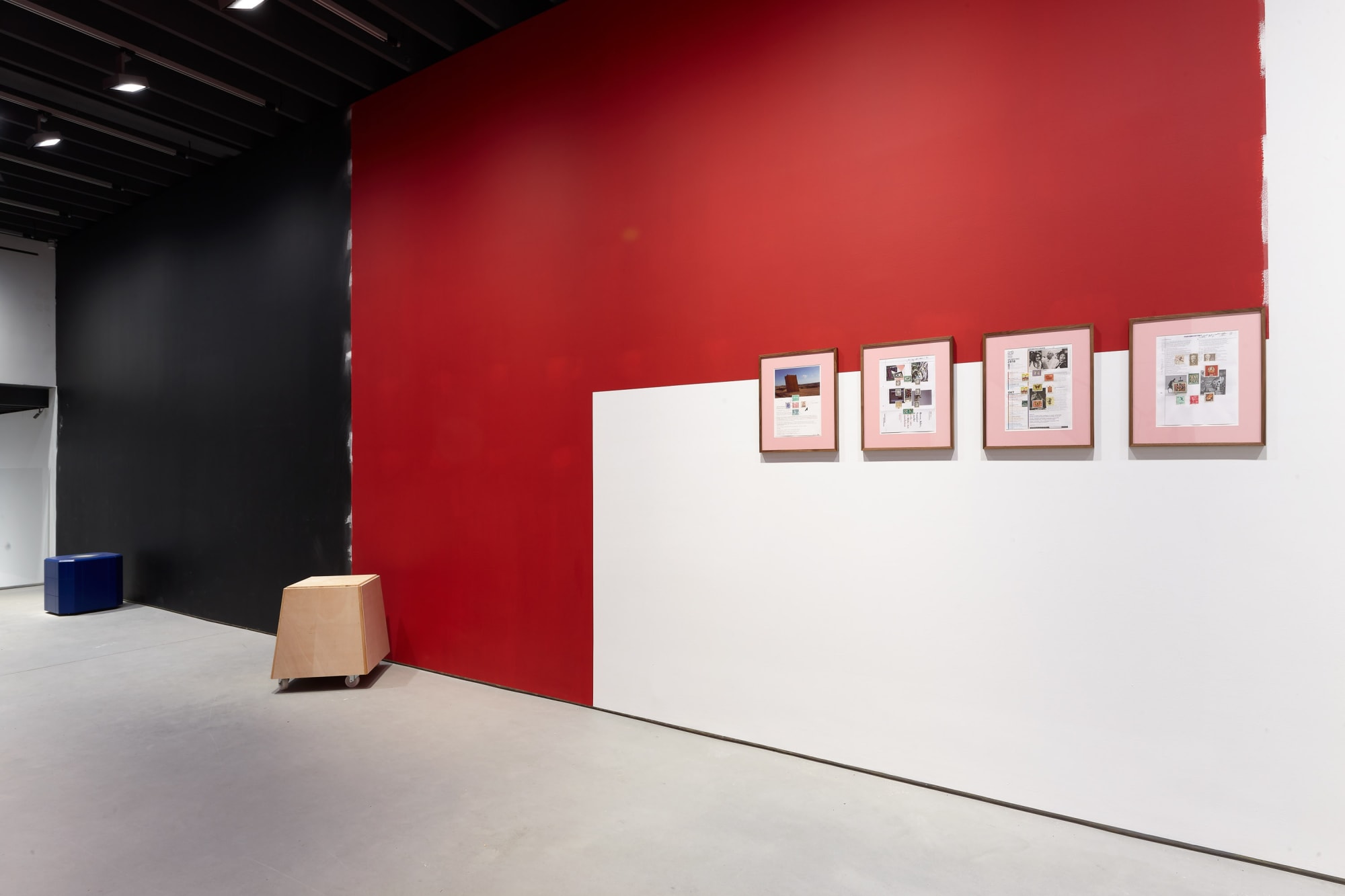 Installation view of Manfred Pernice's exhibition of sculptures involving architecture language. Red walls.