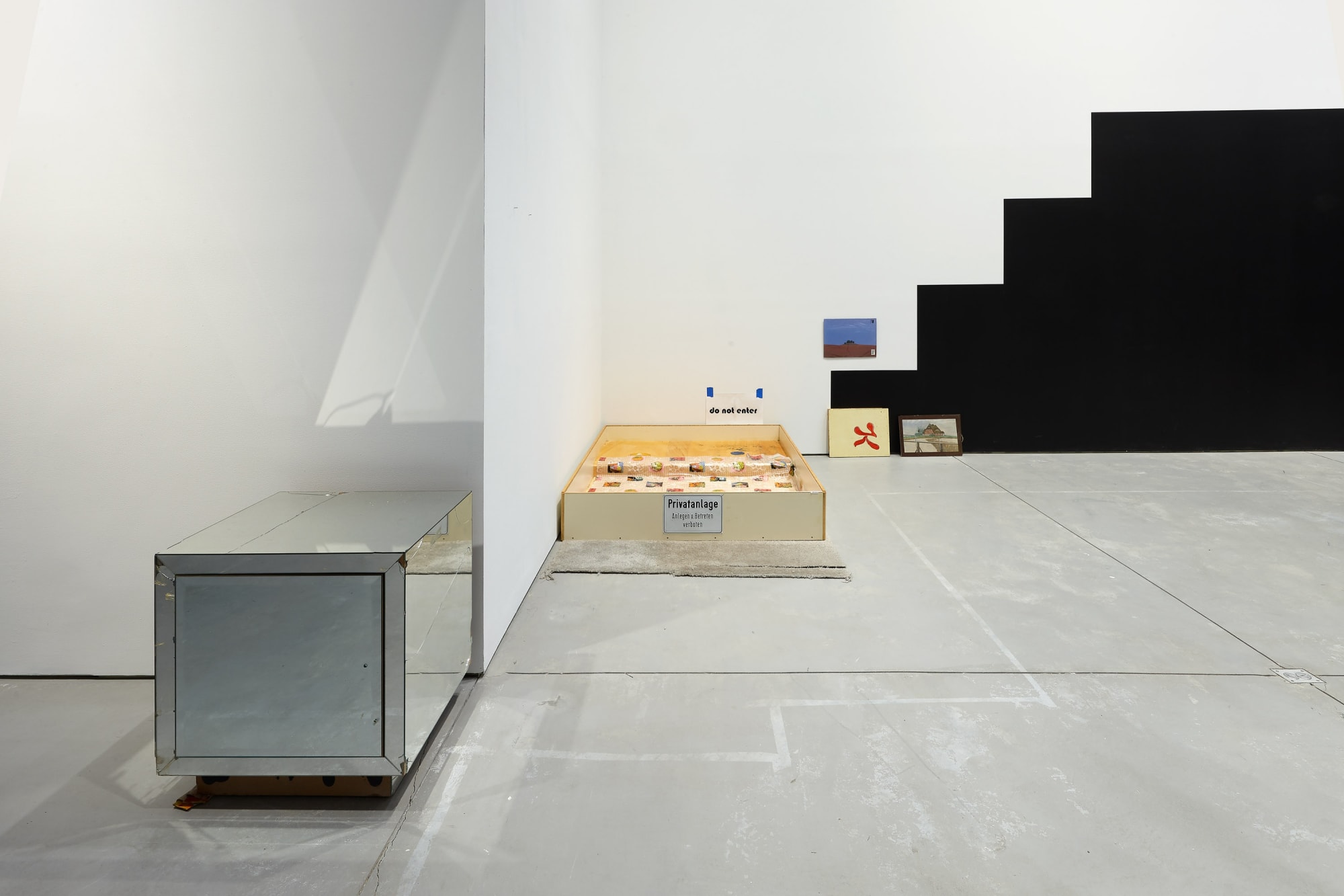 Installation view of Manfred Pernice's exhibition of sculptures involving architecture language. Front desk and back wall visible.