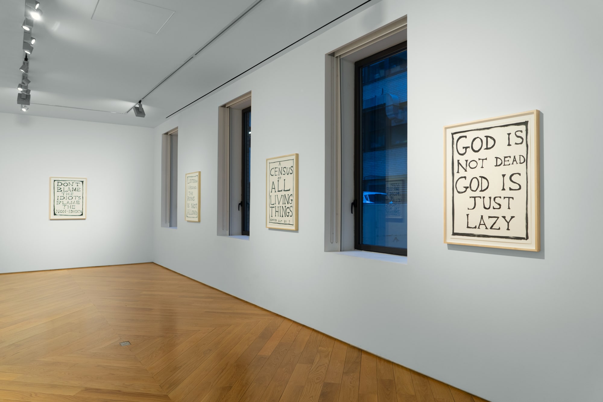 Installation view of David Shrigley's exhibition in the third floor viewing room of his ink text drawings.